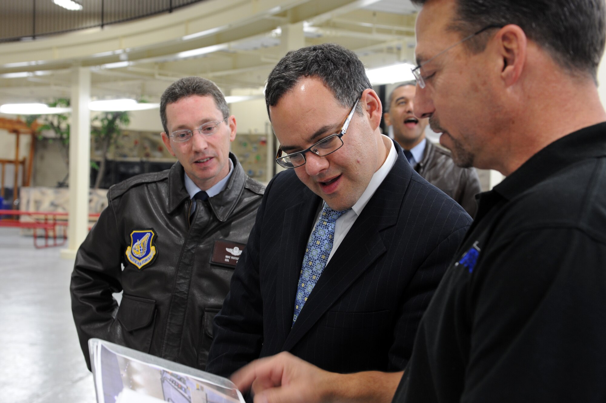 MISAWA AIR BASE, Japan – Bill Gurr, right, 35th Force Support Squadron, shows Daniel B. Ginsberg, Assistant Secretary of the Air Force for Manpower and Reserve Affairs, center, and Col. Michael D. Rothstein, 35th Fighter Wing commander, the many things the Weasels’ Den, a base community center, has to offer during a base tour here Nov. 28. Ginsberg visited base facilities and expressed his gratitude to the Misawa community for their efforts during Operation Tomodachi. (U.S. Air Force Photo/Airman 1st Class Kia Atkins)