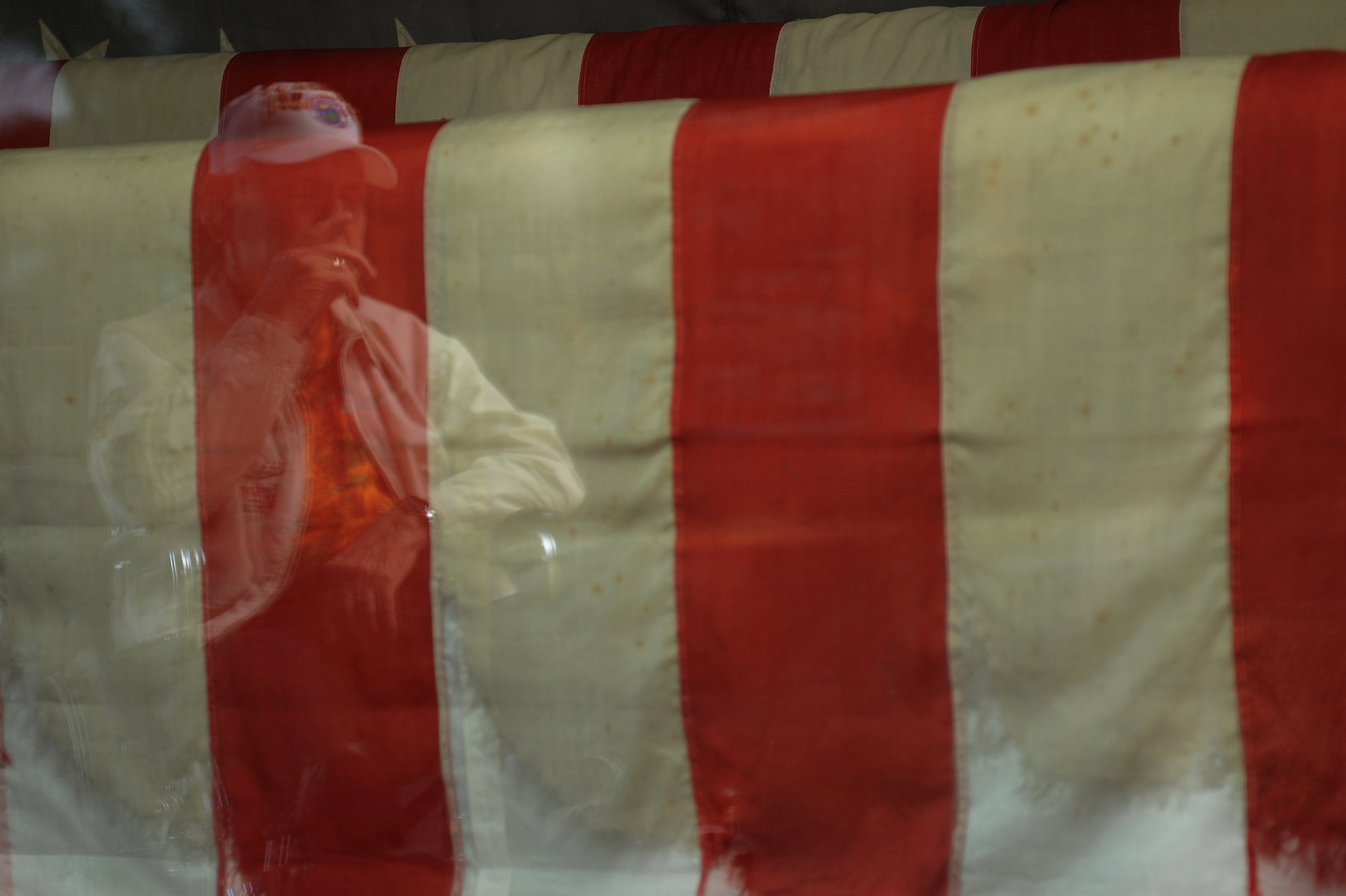 Durward Swanson, Dec. 7, 1941, Hickam Field survivor, looks upon the torn and tattered American Flag that sits in the Pacific Air Forces Headquarters building on Nov. 24, 2011. Swanson was a U.S. Army Air Corps motorcycle patrolman at Hickam when the Japanese attacked the bases on the Island of Oahu 70 years ago. Swanson and his best friend Albert Lloyd pulled the flag off the flag pole at around 9 p.m. on the same night. (U.S. Air Force photo by Staff Sgt. Mike Meares)