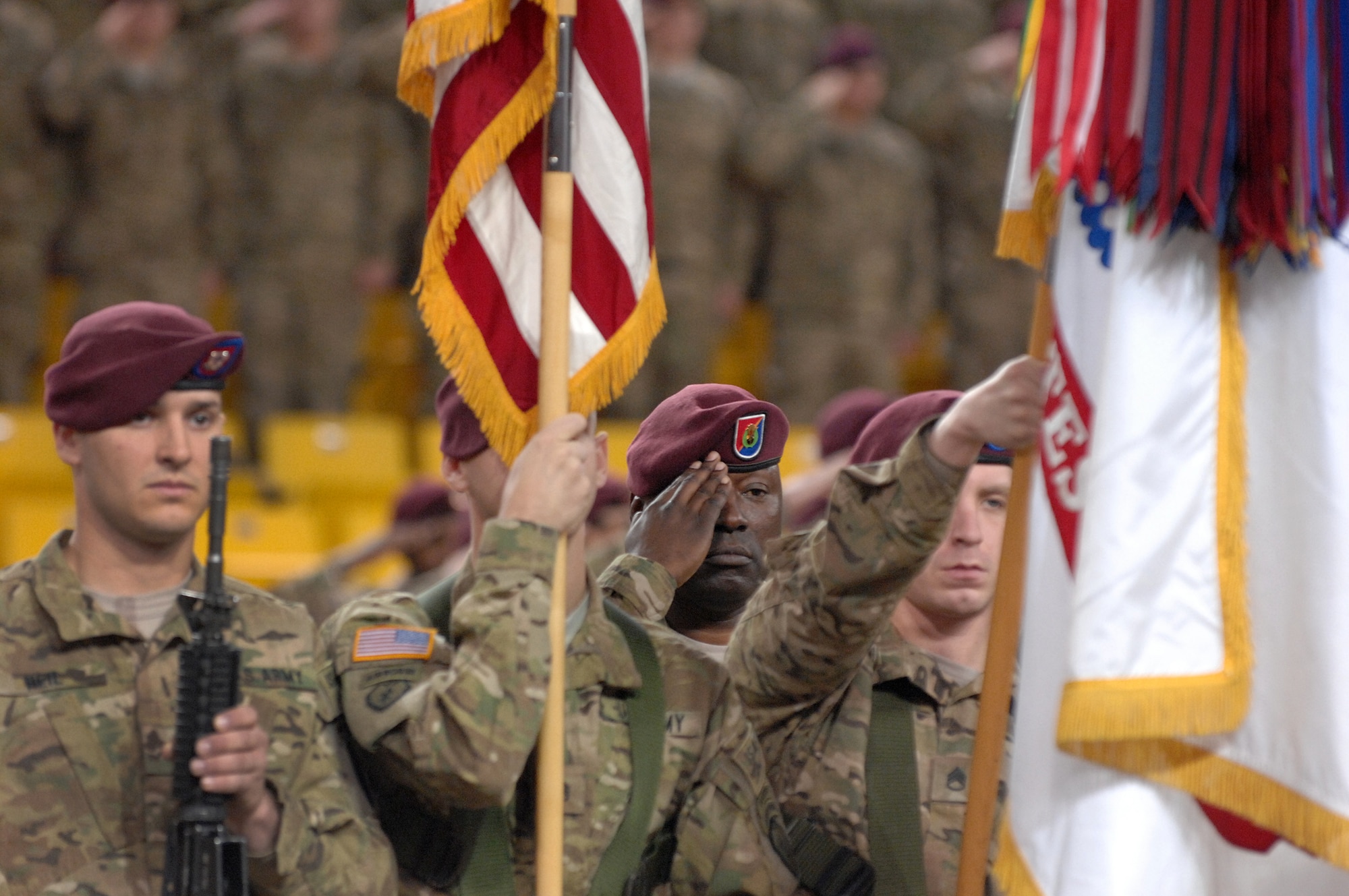 Command Sgt. Maj. Terry Gardner, 4th Brigade Combat Team (Airborne), 25th Infantry Division, salutes during the playing of the national anthem during the 4-25th ABCT's deployment ceremony at Sullivan Arena, Anchorage, Alaska, Nov. 29, 2011.  The 4-25th ABCT, "Spartan Brigade," will deploy 3,500 Soldiers on a series of flights in November and December en route to Afghanistan. (U.S. Air Force photo/Staff Sgt. Zachary Wolf)
