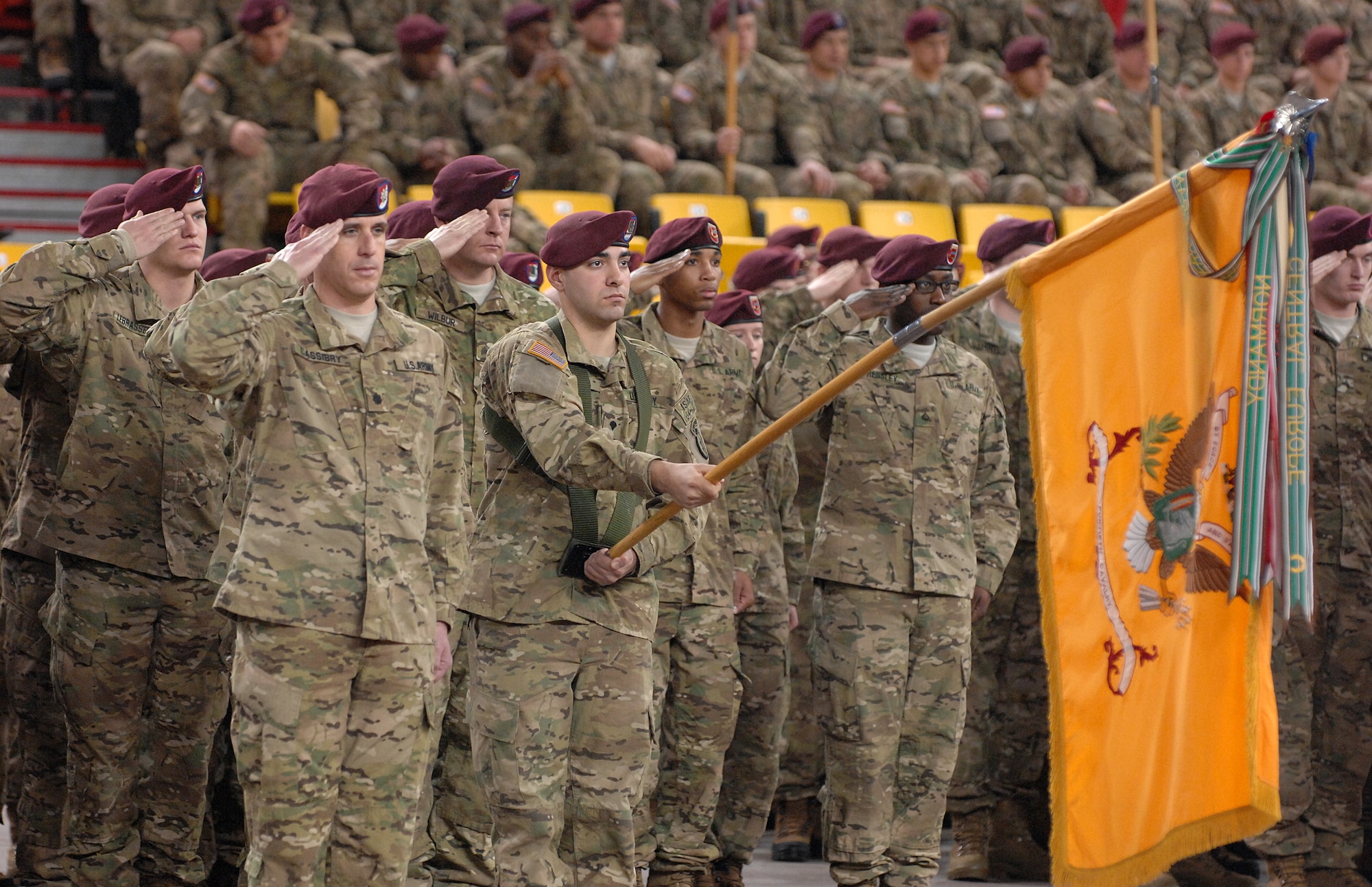 Soldiers of the 1st Squadron (Airborne), 40th Cavalry Regiment, salute during the national anthem at the 4th Brigade Combat Team (Airborne), 25th Infantry Division's deployment ceremony at Sullivan Arena, Anchorage, Alaska, Nov. 29, 2011.  The 4-25th ABCT, "Spartan Brigade," will deploy 3,500 Soldiers on a series of flights in November and December en route to Afghanistan. (U.S. Air Force photo/Staff Sgt. Zachary Wolf)
