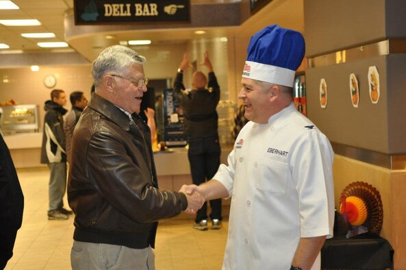 Col. Paul Eberhart, 62nd Operations Group commander, greets a retiree during the Thanksgiving Day meal Nov. 24, 2011, at the Olympic Dining Facility, Joint Base Lewis-McChord, Wash. (U.S. Air Force photo/Tech. Sgt. Oshawn Jefferson)