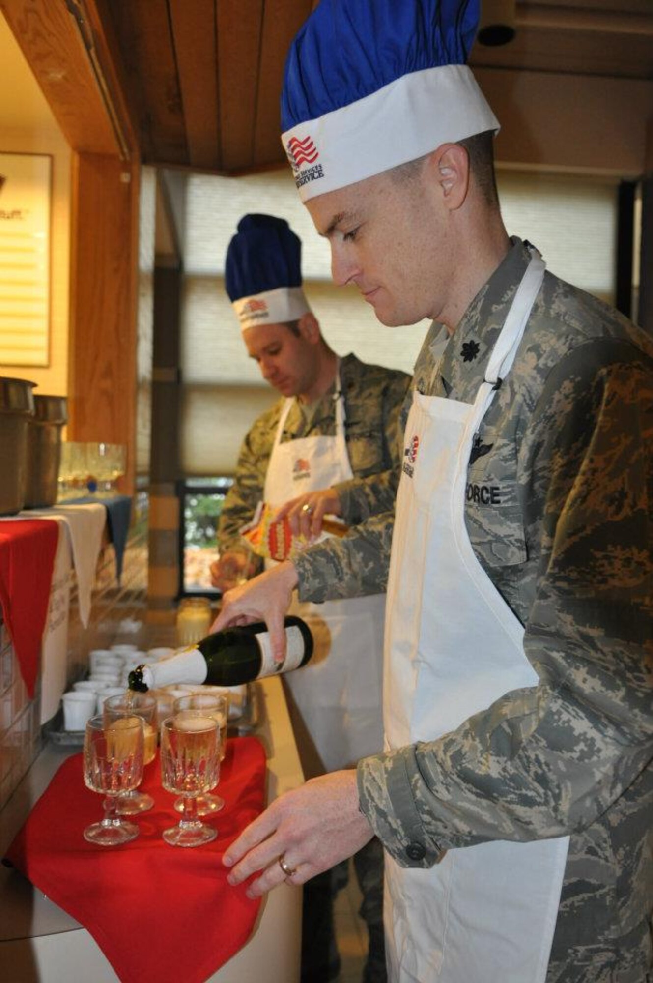 Lt. Col. Eric Carney, 7th Airlift Squadron commander, pours sparkling apple cider and egg nog Nov. 24, 2011, during the Thanksgiving Day meal at the Olympic Dining Facility, Joint Base Lewis-McChord, Wash. (U.S. Air Force photo/Tech. Sgt. Oshawn Jefferson)