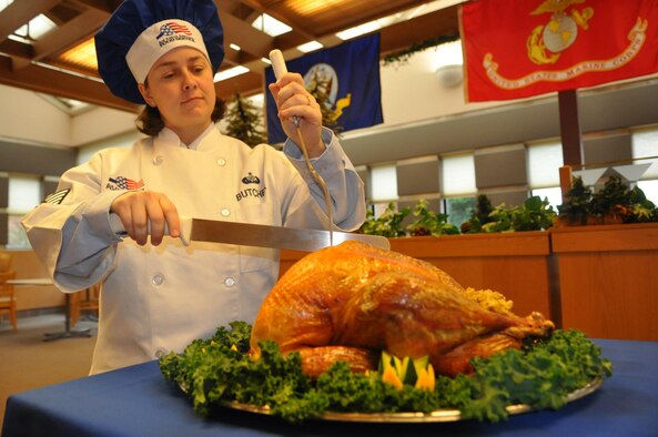 Tech. Sgt. Sarah Butcher, 627th Force Support Squadron dining facility manager, starts to carve a turkey during the Thanksgiving Day meal Nov. 24, 2011, at the Olympic Dining Facility, Joint Base Lewis-McChord, Wash. (U.S. Air Force photo/Tech. Sgt. Oshawn Jefferson)