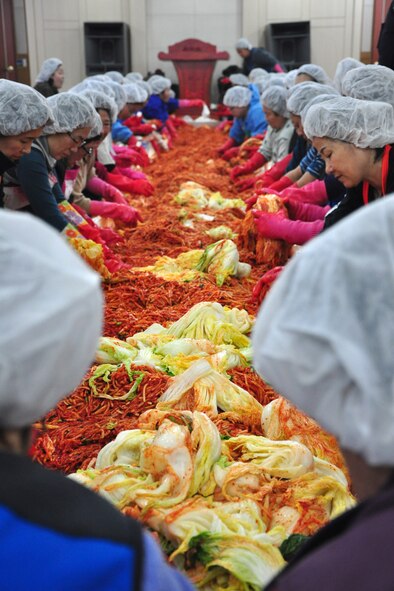 As part of the Good Neighbor Program, Osan and local community members came together Nov. 28 and 29 to prepare nearly 6,000 pounds of kimchi for the holidays in order to help those less fortunate in Songtan. About 200 volunteers helped chop, wash, prep, mix and box nearly 420, 15-pound boxes of kimchi, which will go to 420 local families. (U.S. Air Force photo/Tech. Sgt. Chad Thompson)