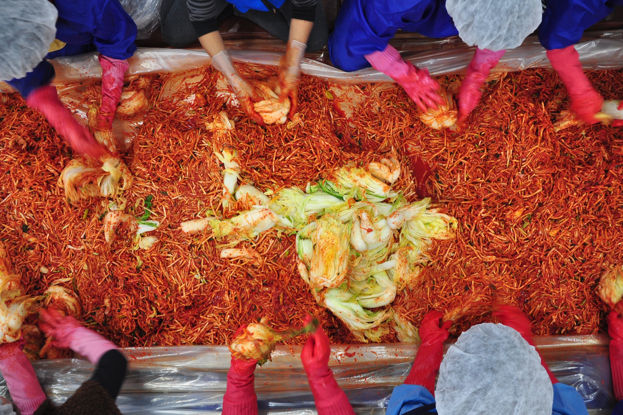 As part of the Good Neighbor Program, Osan and local community members came together Nov. 28 and 29 to prepare nearly 6,000 pounds of kimchi for the holidays in order to help those less fortunate in Songtan. About 200 volunteers helped chop, wash, prep, mix and box nearly 420, 15-pound boxes of kimchi, which will go to 420 local families. (U.S. Air Force photo/Tech. Sgt. Chad Thompson)