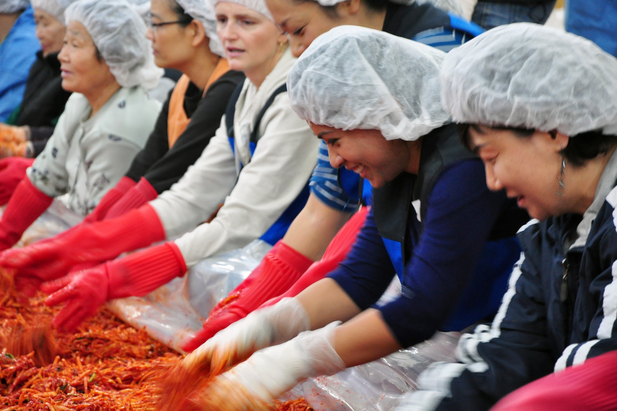 As part of the Good Neighbor Program, Osan and local community members came together Nov. 28 and 29 to prepare nearly 6,000 pounds of kimchi for the holidays in order to help those less fortunate in Songtan. About 200 volunteers helped chop, wash, prep, mix and box nearly 420, 15-pound boxes of kimchi, which will go to 420 local families. (U.S. Air Force photo/Tech. Sgt. Chad Thompson)