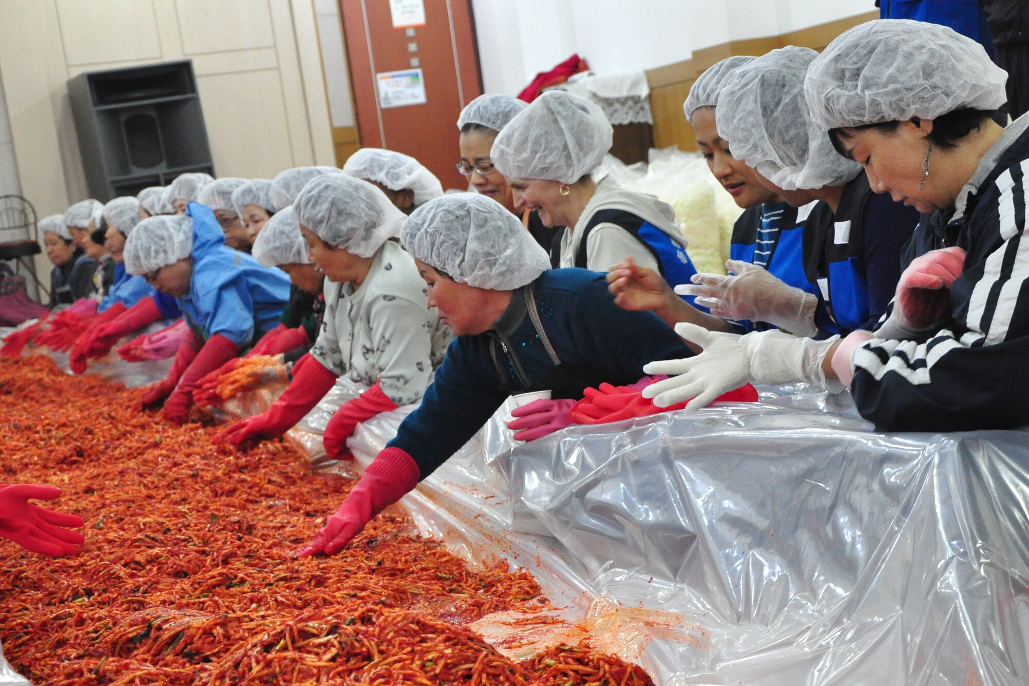 As part of the Good Neighbor Program, Osan and local community members came together Nov. 28 and 29 to prepare nearly 6,000 pounds of kimchi for the holidays in order to help those less fortunate in Songtan. About 200 volunteers helped chop, wash, prep, mix and box nearly 420, 15-pound boxes of kimchi, which will go to 420 local families. (U.S. Air Force photo/Tech. Sgt. Chad Thompson)