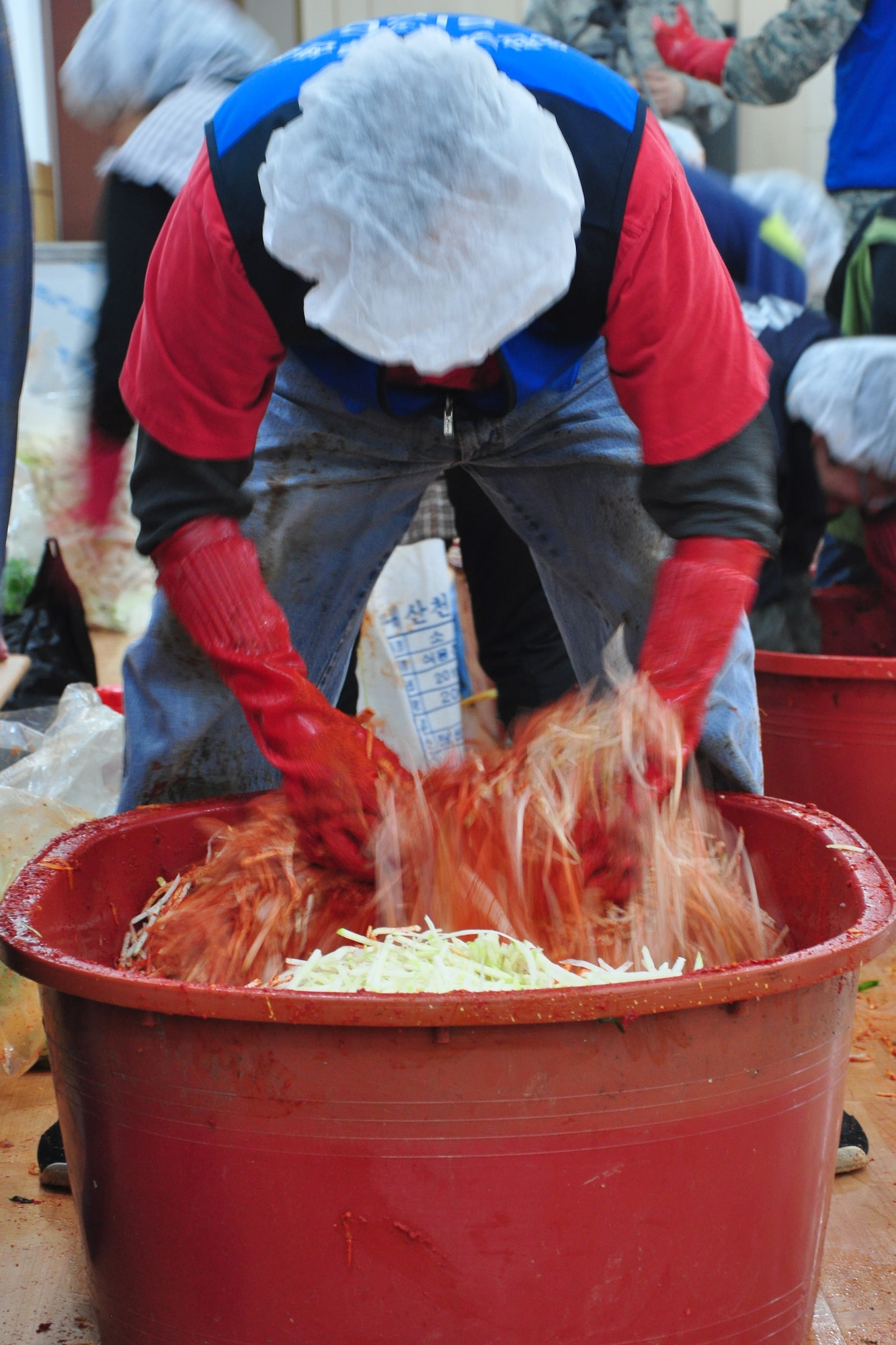 As part of the Good Neighbor Program, Osan and local community members came together Nov. 28 and 29 to prepare nearly 6,000 pounds of kimchi for the holidays in order to help those less fortunate in Songtan. About 200 volunteers helped chop, wash, prep, mix and box nearly 420, 15-pound boxes of kimchi, which will go to 420 local families. (U.S. Air Force photo/Tech. Sgt. Chad Thompson)