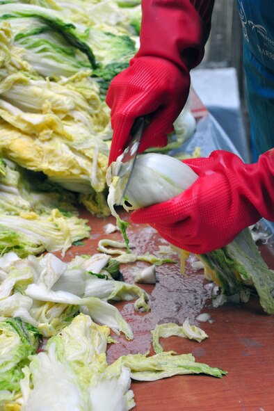 As part of the Good Neighbor Program, Osan and local community members came together Nov. 28 and 29 to prepare nearly 6,000 pounds of kimchi for the holidays in order to help those less fortunate in Songtan. About 200 volunteers helped chop, wash, prep, mix and box nearly 420, 15-pound boxes of kimchi, which will go to 420 local families. (U.S. Air Force photo/Tech. Sgt. Chad Thompson)