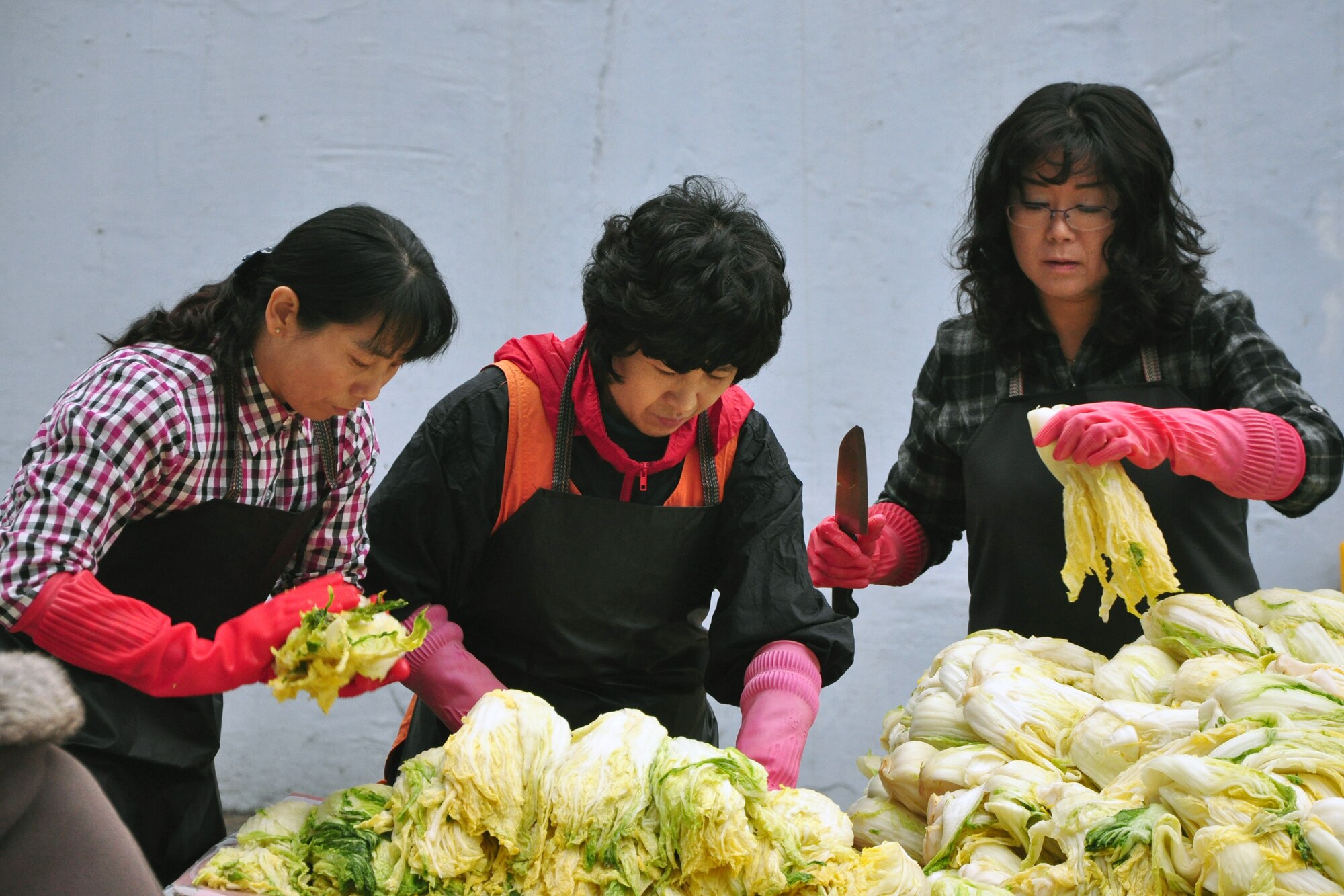 As part of the Good Neighbor Program, Osan and local community members came together Nov. 28 and 29 to prepare nearly 6,000 pounds of kimchi for the holidays in order to help those less fortunate in Songtan. About 200 volunteers helped chop, wash, prep, mix and box nearly 420, 15-pound boxes of kimchi, which will go to 420 local families. (U.S. Air Force photo/Tech. Sgt. Chad Thompson)