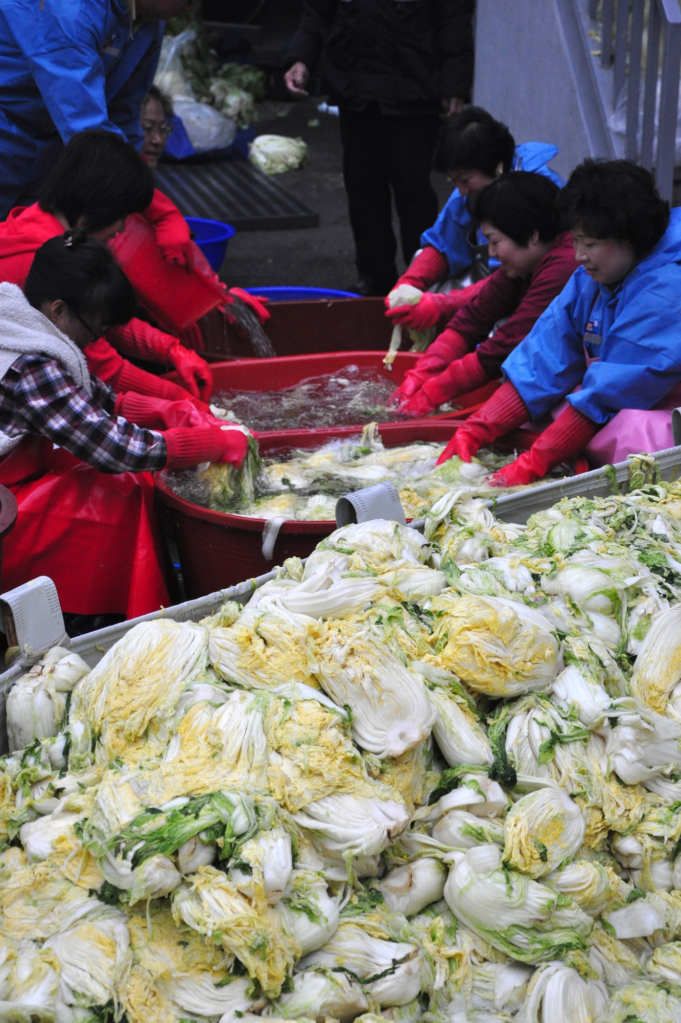 As part of the Good Neighbor Program, Osan and local community members came together Nov. 28 and 29 to prepare nearly 6,000 pounds of kimchi for the holidays in order to help those less fortunate in Songtan. About 200 volunteers helped chop, wash, prep, mix and box nearly 420, 15-pound boxes of kimchi, which will go to 420 local families. (U.S. Air Force photo/Tech. Sgt. Chad Thompson)