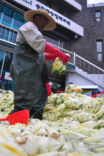 As part of the Good Neighbor Program, Osan and local community members came together Nov. 28 and 29 to prepare nearly 6,000 pounds of kimchi for the holidays in order to help those less fortunate in Songtan. About 200 volunteers helped chop, wash, prep, mix and box nearly 420, 15-pound boxes of kimchi, which will go to 420 local families. (U.S. Air Force photo/Tech. Sgt. Chad Thompson)