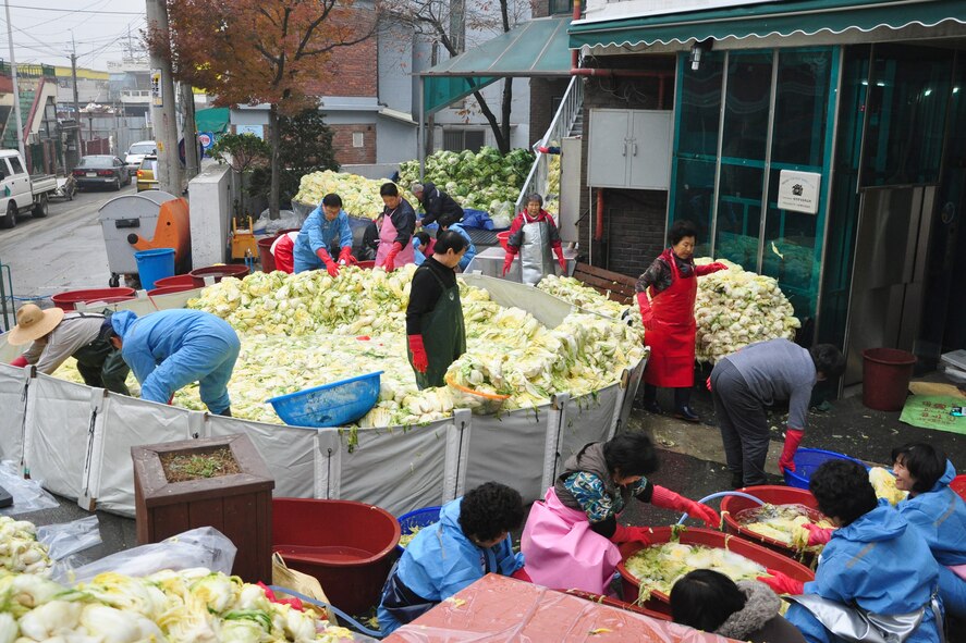 As part of the Good Neighbor Program, Osan and local community members came together Nov. 28 and 29 to prepare nearly 6,000 pounds of kimchi for the holidays in order to help those less fortunate in Songtan. About 200 volunteers helped chop, wash, prep, mix and box nearly 420, 15-pound boxes of kimchi, which will go to 420 local families. (U.S. Air Force photo/Tech. Sgt. Chad Thompson)