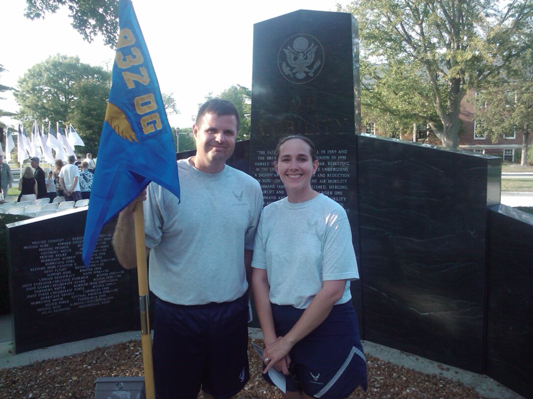 Master Sgt. Chad Welch and Staff Sgt. Karen Ridge, 932nd Aeromedical Evacuation Squadron, stand in front of a memorial to the fall of the Berlin Wall following a Memorial Run/Walk.The memorial run/walk was in remembrance of the Sept. 11, 2001 attacks. “It wasn’t a race; it was simply a time to reflect and remember the events of that day, as well as those who gave their lives,” said Ridge. A piece of the World Trade Center was dedicated during the ceremony following the run. “It was very moving and powerful.” (Courtesy photo)