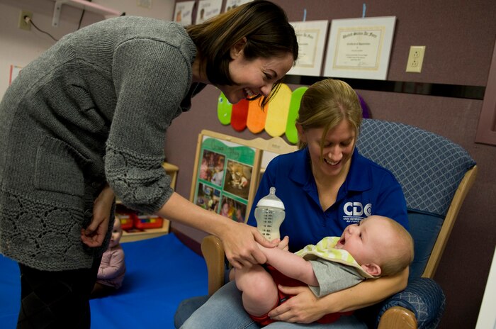 Christina Hillard, wife of Tech. Sgt. Cristopher Hillard, 57th Maintenance Group weapons specialist, and Sarah Irick, Nellis Child Development Center childcare provider, play with Noah Hillard Nov. 28, 2011, at CDC III on Nellis Air Force Base, Nev. The 99th Force Support Squadron earned an overall best award for its child development program in the 2011 manpower awards at the Air Combat Command level. The 99 FSS will compete in the Air Force-level awards in March 2012. (U.S Air Force photo by Senior Airman Stephanie Rubi / Released)