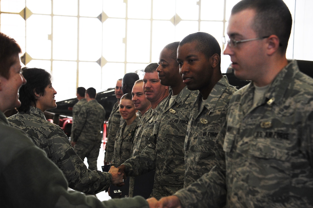 Lt. Col. Monica Madero, 364th Training Squadron commander, and Master Sergeant Laurel Duncil, 364th TRS first sergeant, lead the line of instructors, friends and family members as they shake the hands of Airmen who graduated from the Electrical and Environmental Systems Apprentice course Nov. 23, 2011 at Sheppard Air Force base, Texas. With 49 academic days for each class and as many as 10 classes running concurrently, the course is scheduled to graduate approximately 420 students in fiscal year 2012. (U.S. Air Force photo/Senior Airman Adawn Kelsey)