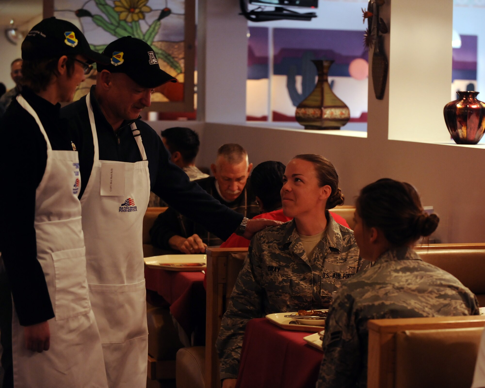 Congresswoman Gabrielle Giffords and retired U.S. Navy Capt. Mark Kelly talk with service members in the Desert Dining Inn on Davis-Monthan Air Force Base, Ariz. Nov. 24, 2011. Giffords and Kelly spoke with service members after taking part in serving them Thanksgiving lunch. (U.S. Air Force photo by Airman 1st Class Timothy D. Moore/Released)