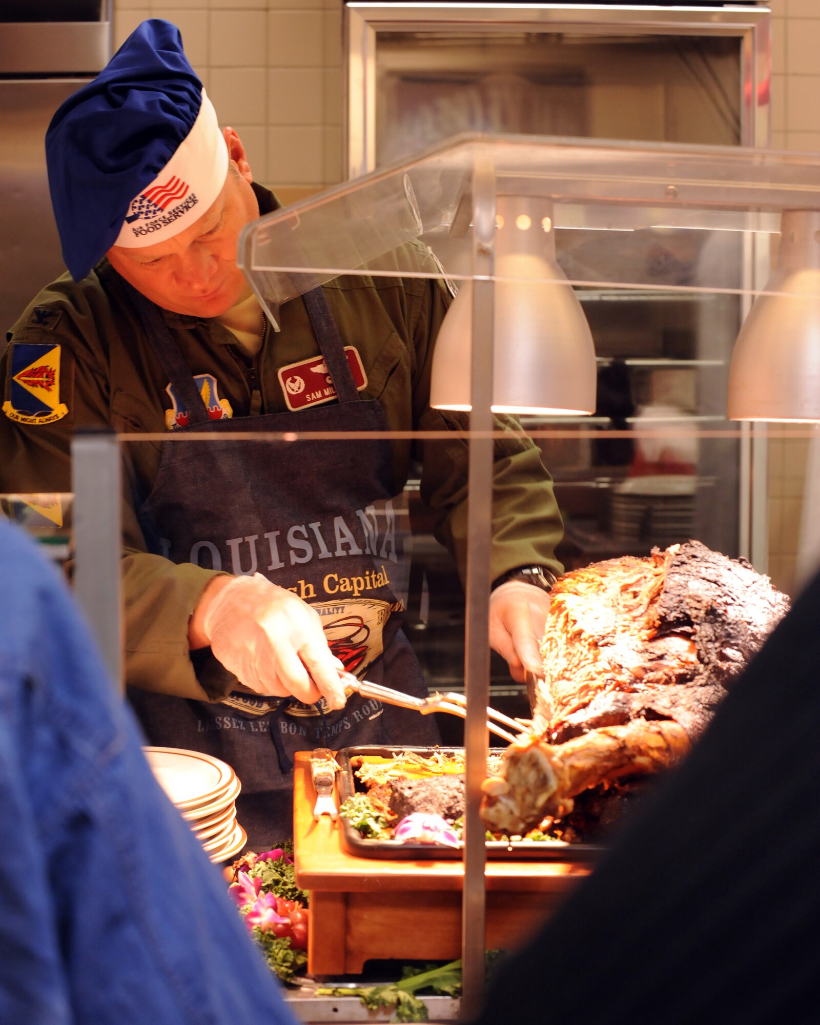 U.S. Air Force Col. Samuel Milam, 355th Operations Group commander, carves a roast in the Desert Dining Inn on Davis-Monthan Air Force Base, Ariz. Nov. 24, 2011. D-M leadership served Thanksgiving meals to retired and current U.S. armed forces members. (U.S. Air Force photo by Airman 1st Class Timothy D. Moore/Released)