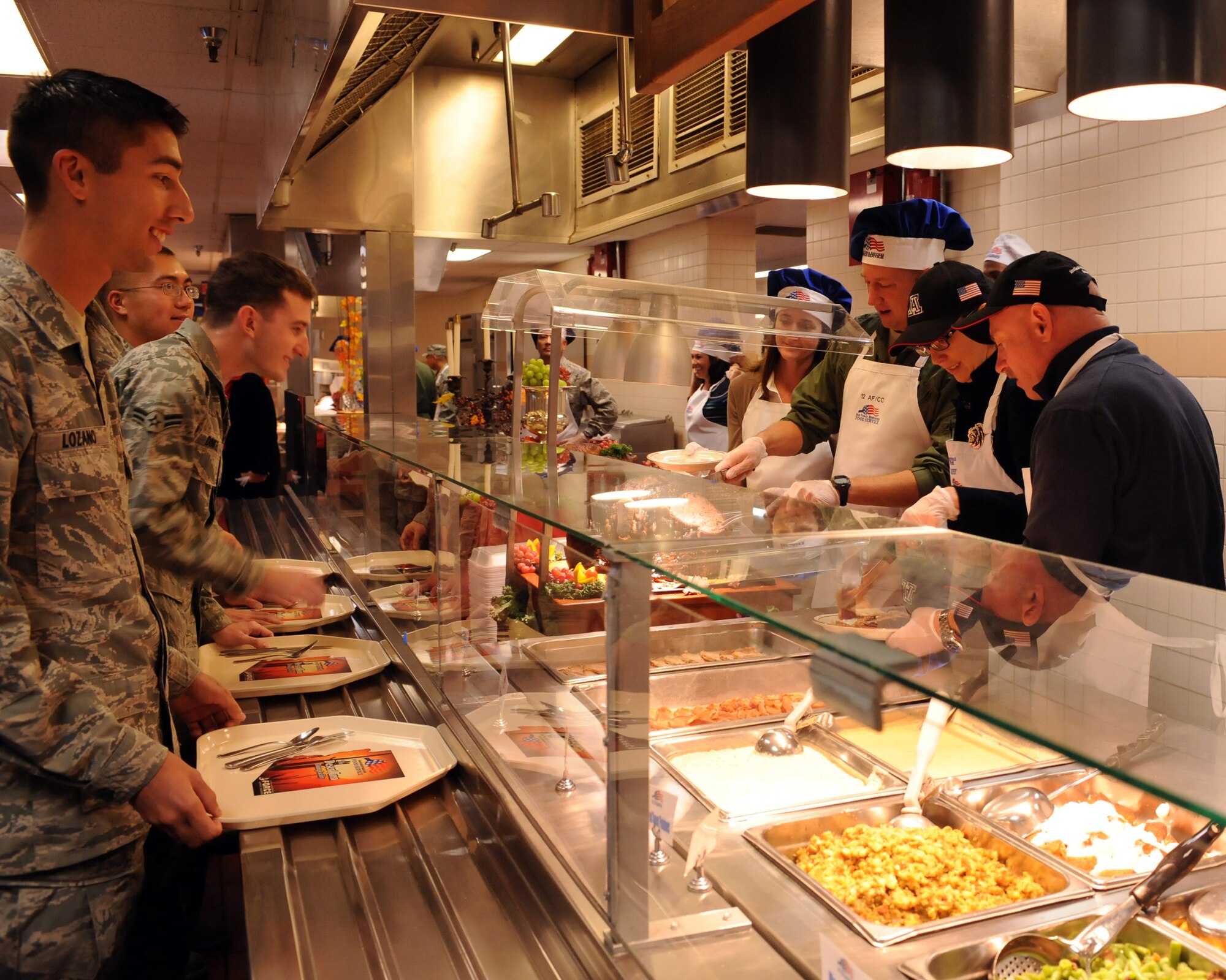 U.S. Air Force Brig. Gen. Jon Norman, 12th Air Force (Air Forces Southern) vice commander, Congresswoman Gabrielle Giffords, and Giffords’ husband retired U.S. Navy Capt. Mark Kelly serve Thanksgiving lunch to Airmen in the Desert Dining Inn on Davis-Monthan Air Force Base, Ariz. Nov. 24, 2011. Giffords and Kelly joined Norman and other D-M leadership in serving troops and their families. (U.S. Air Force photo by Airman 1st Class Timothy D. Moore/Released)