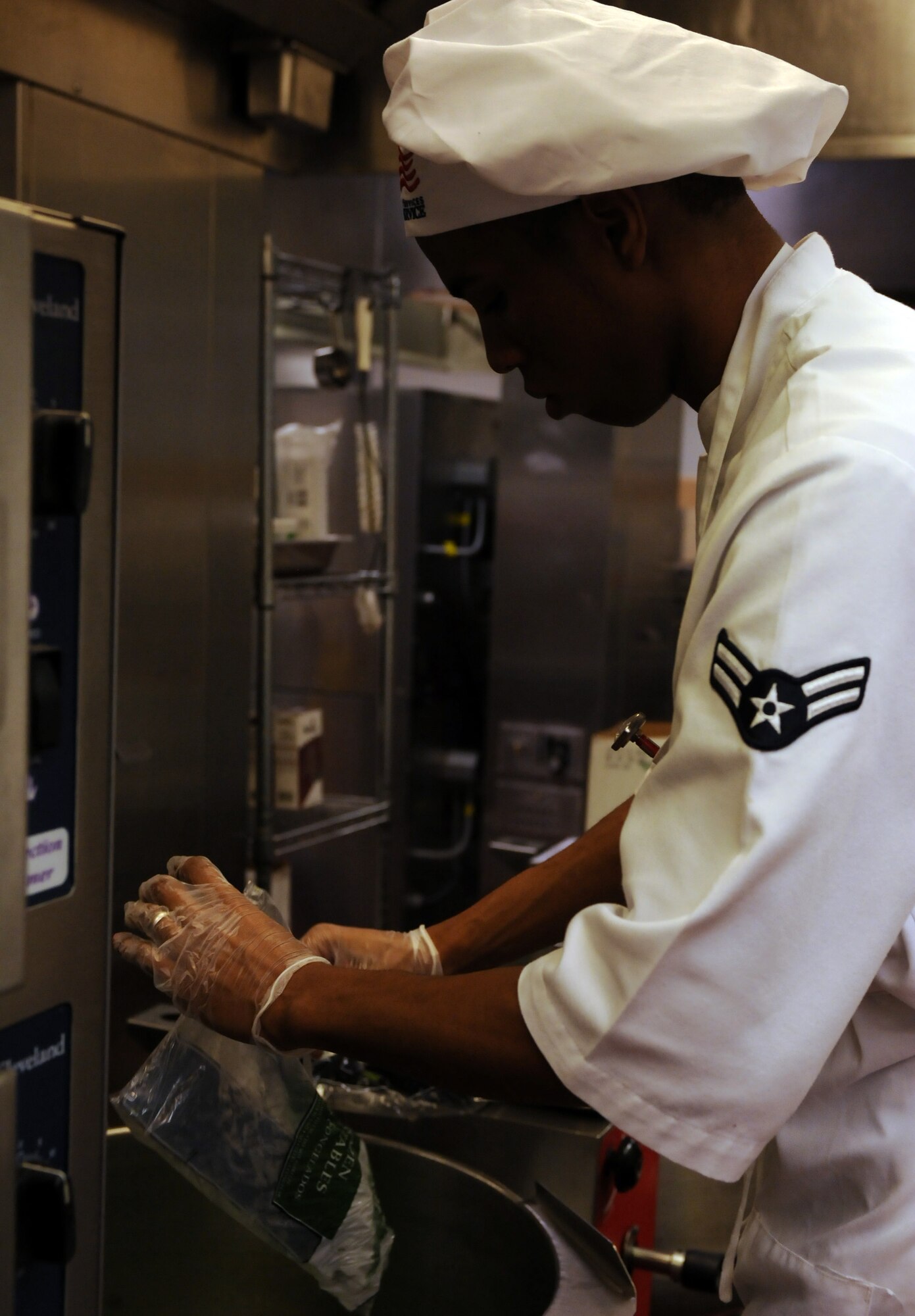 U.S. Air Force Airman 1st Class Michael White, 355th Force Support Squadron, pours green beans into a boiler in the Desert Dining Inn on Davis-Monthan Air Force Base, Ariz. Nov. 24, 2011. White helped prepare the Thanksgiving lunch for U.S. armed service members, both past and present, and their families. (U.S. Air Force photo by Airman 1st Class Timothy D. Moore/Released)
