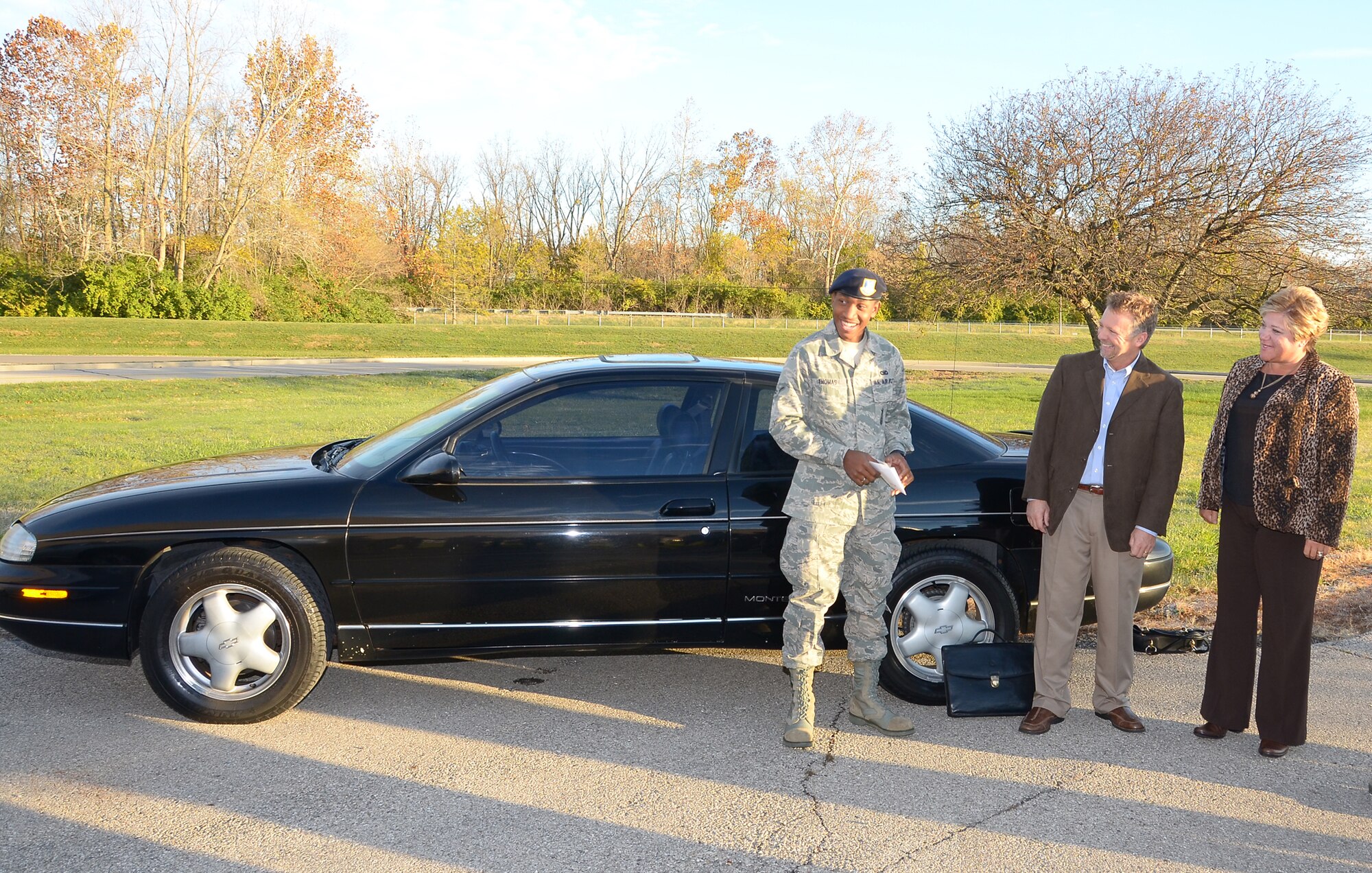 WRIGHT-PATTERSON AIR FORCE BASE, Ohio - Airman Lamont Thomas, 445th Security Force Squadron journeyman, receives a car Nov. 5 from Dave and Jan Murphy, owners of Murphy’s Autocare of Beavercreek, Ohio, as part of the Charity Cars Program. (U.S. Air Force photo/Tech. Sgt. Jeremy Caskey)