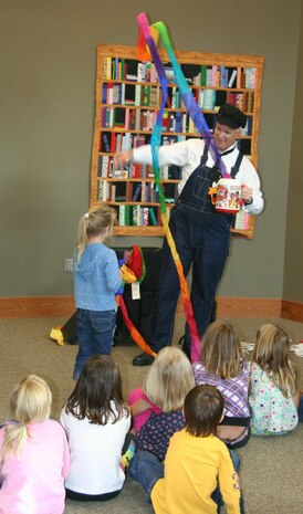 Master Sgt. Perry Woods surprises a young audience member by making a white dove, Ozzy, vanish before her eyes. Later, Woods placed a balloon front and center to the audience and Ozzy reappeared after the balloon wass popped. Woods is a 437th Airlift Wing programs manager at Joint Base Charleston. 