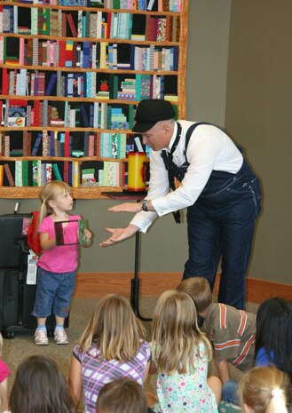 Master Sgt. Perry Woods encourages audience participation to complete a magic trick at a recent show. Woods has volunteered to perform his magic shows for various organizations for the past three years. Woods is a 437th Airlift Wing programs manager at Joint Base Charleston – Air Base. 