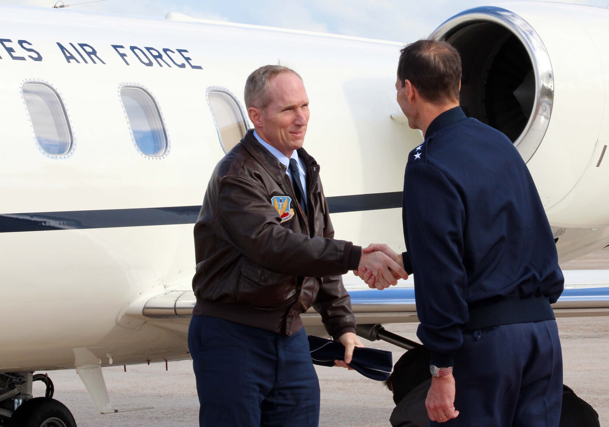 Lt. Gen. Sid Clarke (right), 1st Air Force commander, shakes hands with Gen. Mike Hostage, Air Combat Command commander, after he arrived at Tyndall Air Force Base, Fla., Nov. 28. Hostage visited several organizations at Tyndall during his two-day visit Nov. 28 and 29. (U.S. Air Force photo by Angela Pope) 