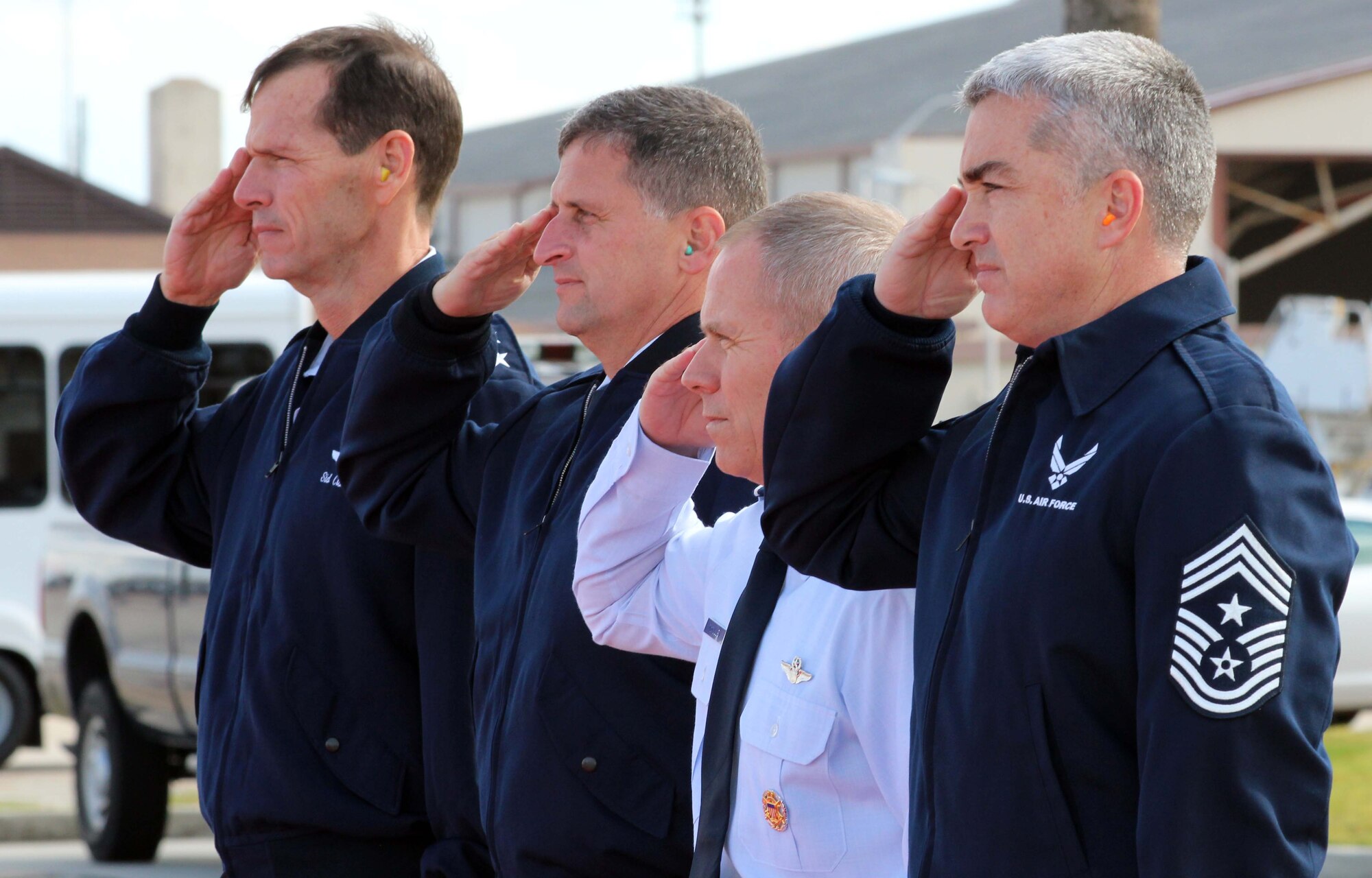 From left, Lt. Gen. Sid Clarke, 1st Air Force commander, Brig. Gen. Robert Beletic, 1st AF vice commander, Brig. Gen. John McMullen, 325th Fighter Wing commander, and Chief Master Sgt. Jackie Green, 325th FW command chief, salute the aircraft of Gen. Mike Hostage, Air Combat Command commander, as it lands at Tyndall Air Force Base, Fla., Nov. 28. Hostage visited several organizations at Tyndall during his two-day visit Nov. 28 and 29. (U.S. Air Force photo by Angela Pope) 