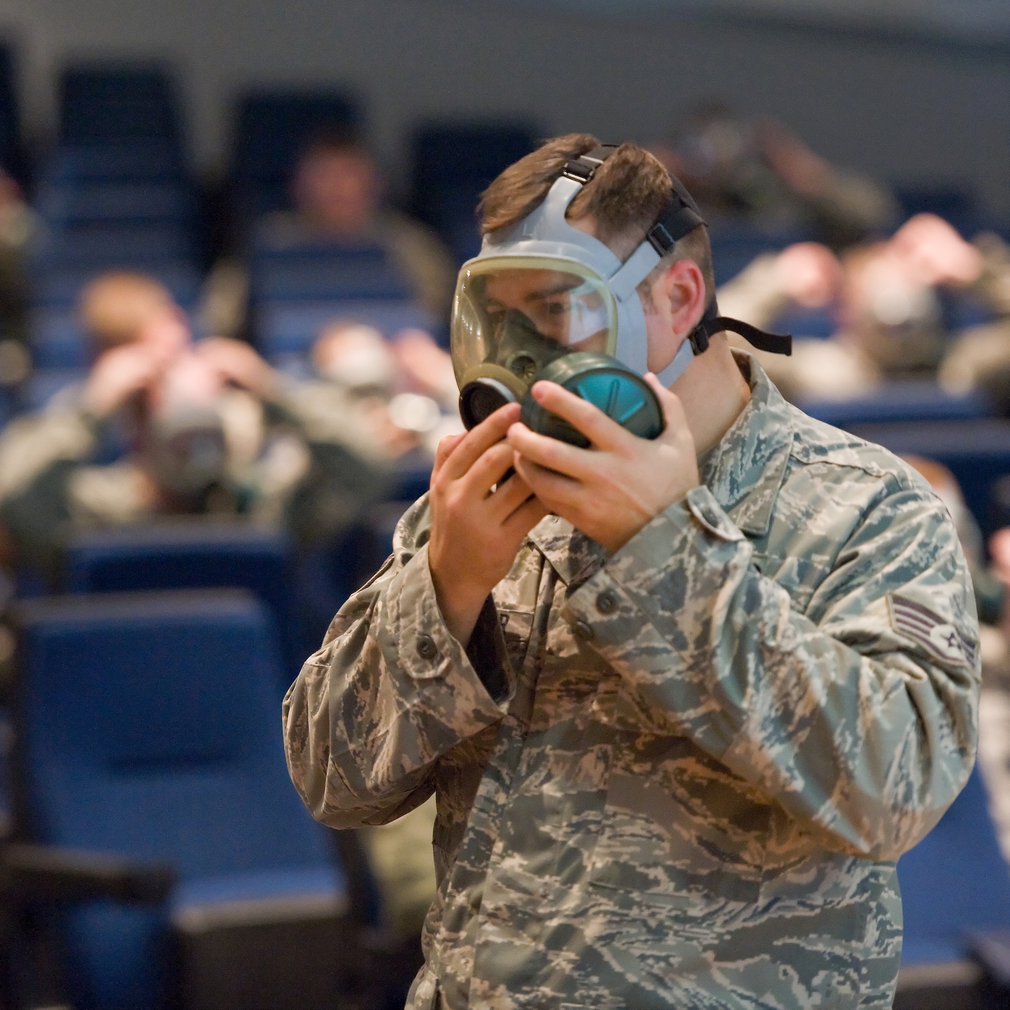 Staff Sgt. Bradley Iseminger, an emergency management instructor with the 436th Civil Engineer Squadron, instructs Team Dover members on the proper inspection and wear of the MCU-2/P mask at the base theater Nov. 28, 2011, Dover Air Force Base, Del. Team Dover members received final Operational Readiness Inspection training as the 436th and 512th Airlift Wings prepare for an upcoming ORI. (U.S. Air Force photo/Roland Balik)