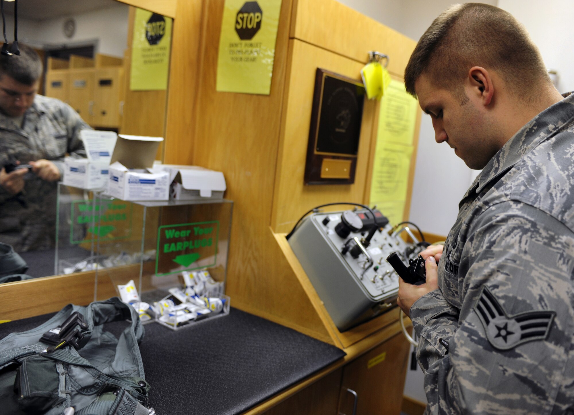 WHITEMAN AIR FORCE BASE, Mo. -- Senior Airman Jacque Olson checks the operational capabilities of a HGU 55/P Light Weight helmet Nov. 22. The helmet is designed to provide enhanced peripheral vision. Life support staff members ensure pilots' survival equipment is in top condition prior to them stepping. Olson is an Aircrew Flight Equipment technician assigned to the 393rd Bomb Squadron. (U.S. Air Force photo/Senior Airman Laura Goodgame) 