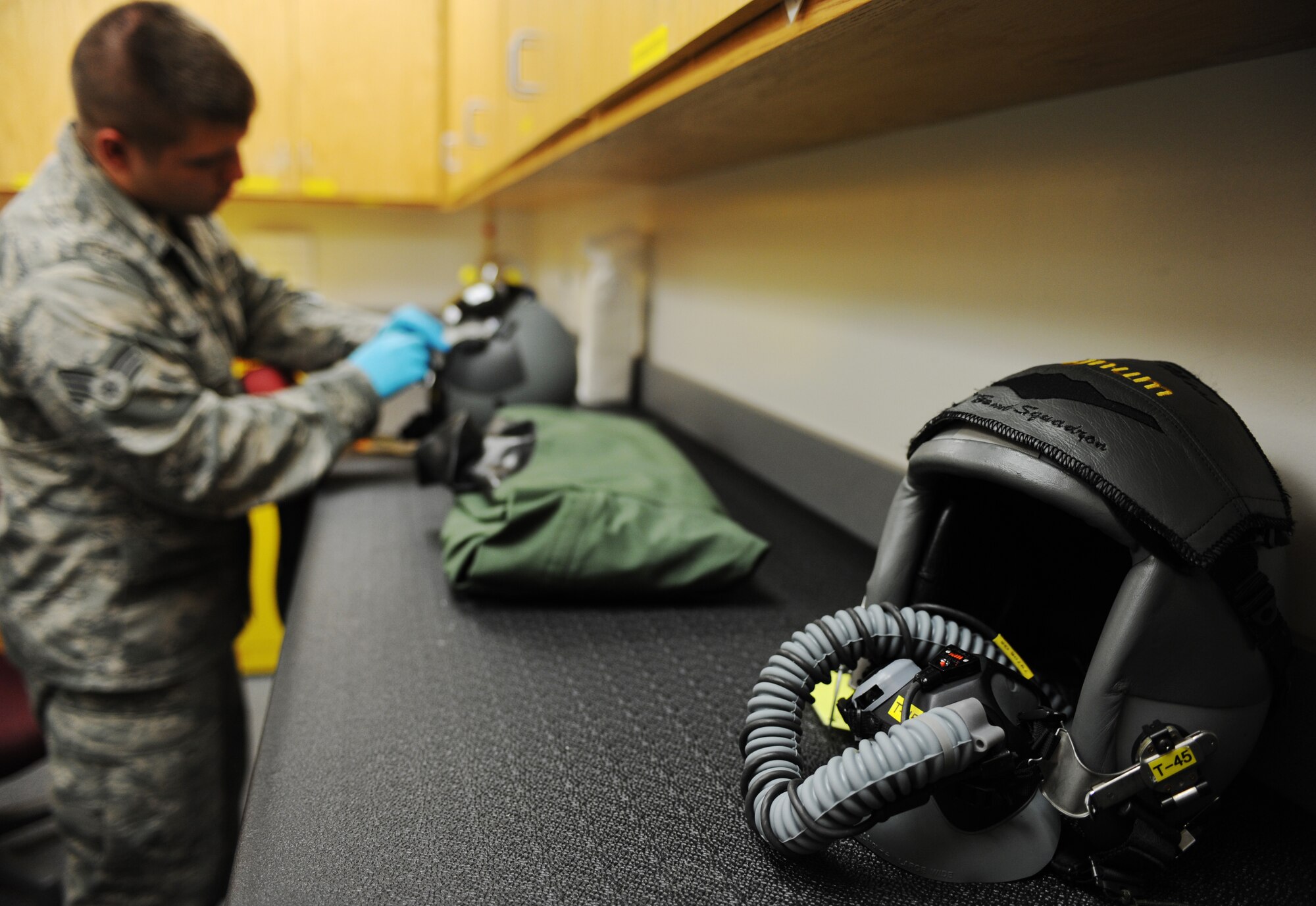 WHITEMAN AIR FORCE BASE, Mo. -- Senior Airman Jacque Olson checks the operational capabilities of a HGU 55/P Light Weight helmet Nov. 22. The helmet is designed to provide enhanced peripheral vision. Life support staff members ensure pilots' survival equipment is in top condition prior to them stepping. Olson is an Aircrew Flight Equipment technician assigned to the 393rd Bomb Squadron. (U.S. Air Force photo/Senior Airman Laura Goodgame) 