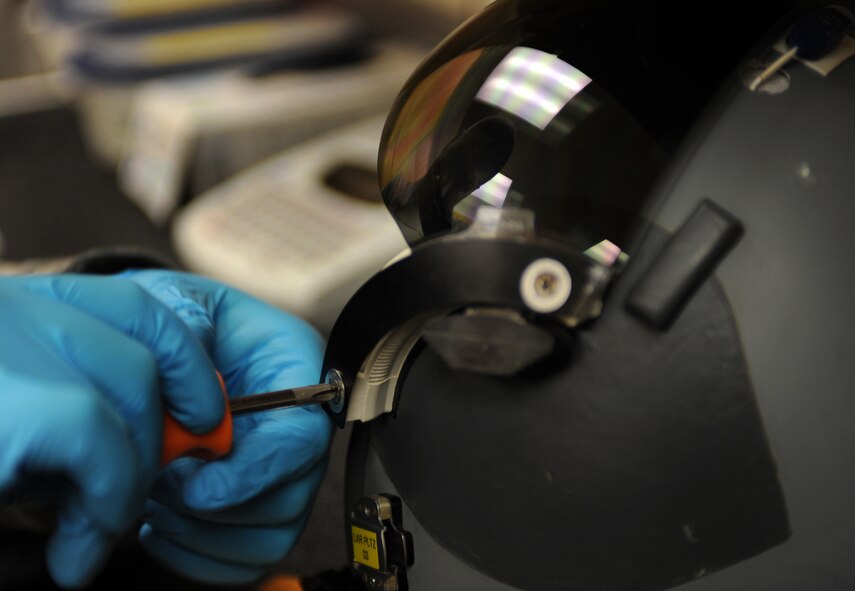 WHITEMAN AIR FORCE BASE, Mo. -- Senior Airman Jacque Olson tightens a screw on a HGU 55/P Light Weight helmet Nov. 22, 2011. The helmet is designed to provide enhanced peripheral vision. Life support staff members ensure pilots' survival equipment is in top condition prior to them stepping. Olson is an Aircrew Flight Equipment technician assigned to the 393rd Bomb Squadron. (U.S. Air Force photo by Senior Airman Laura Goodgame)