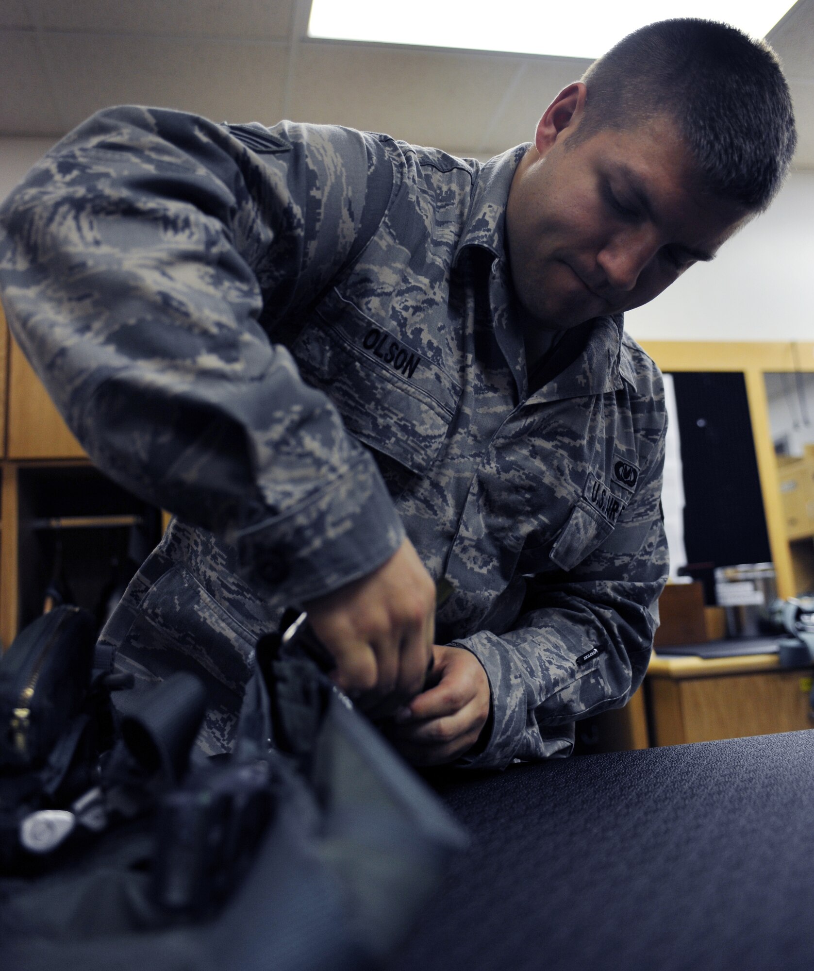 WHITEMAN AIR FORCE BASE, Mo. -- Senior Airman Jacque Olson check to make sure the ejector caps on the survival vest is operational Nov. 22. Life support staff members ensure pilots' survival equipment is in top condition prior to them stepping. Olson is an Aircrew Flight Equipment technician assigned to the 393rd Bomb Squadron. (U.S. Air Force photo/Senior Airman Laura Goodgame) 