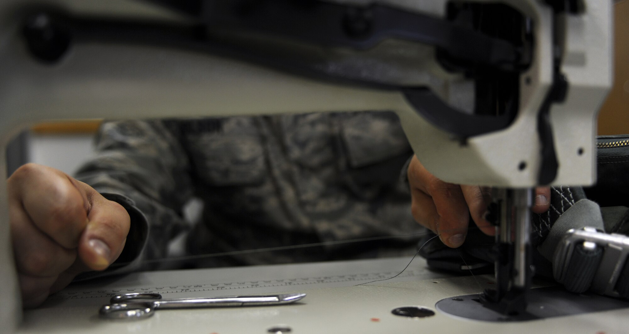 WHITEMAN AIR FORCE BASE, Mo. -- Senior Airman Jacque Olson pulls thread through a sewing needle to repair aircrew flight equipment Nov. 22. Life support staff members ensure pilots' survival equipment is in top condition prior to them stepping. Olson is an Aircrew Flight Equipment technician assigned to the 393rd Bomb Squadron. (U.S. Air Force photo/Senior Airman Laura Goodgame) 