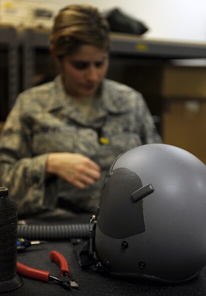 WHITEMAN AIR FORCE BASE, Mo. -- Airman 1st Class Gina Reeves hand threads aircrew flight equipment Nov. 22. It is important to keep survival equipment in top condition because someone?s life may depend on it. Reeves is an Aircrew Flight Equipment Apprentice assigned to the 393rd Bomb Squadron. (U.S. Air Force photo/Senior Airman Laura Goodgame) 