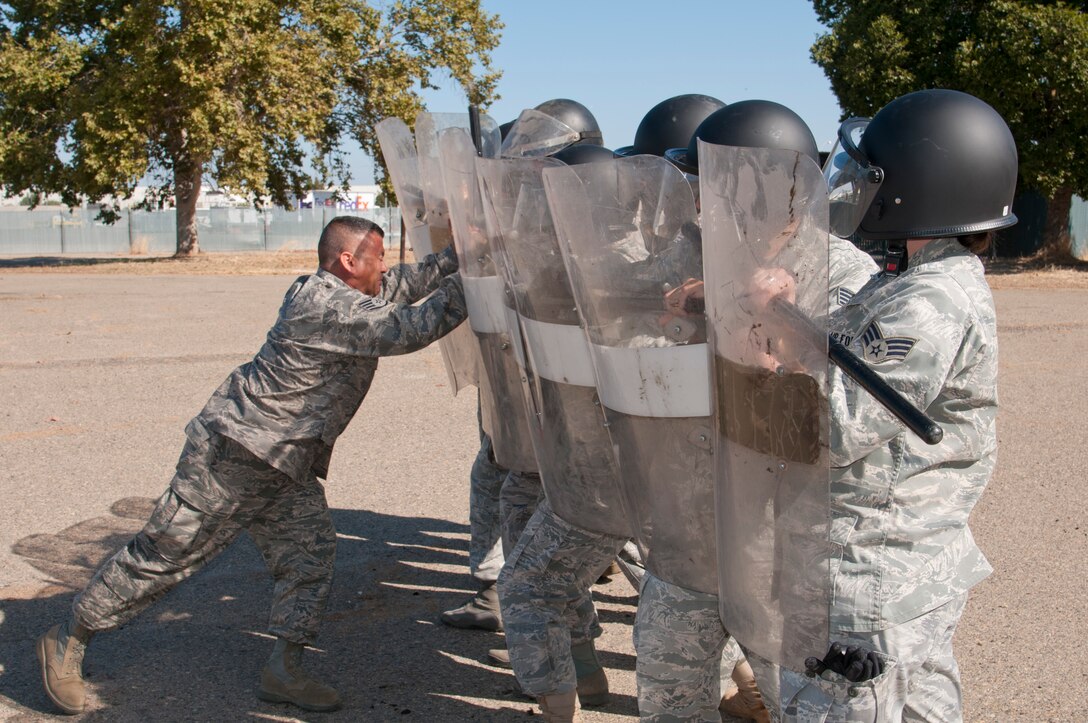 Members of the 144th Security Forces Squadron take part in specialized riot contol training. The special tactics are instructed by Staff Sgt. Raul Amezcua and focus on crowd dispersement, force integrity and protection of assets. (U.S. Air Force photo by Master Sgt. David Loeffler)