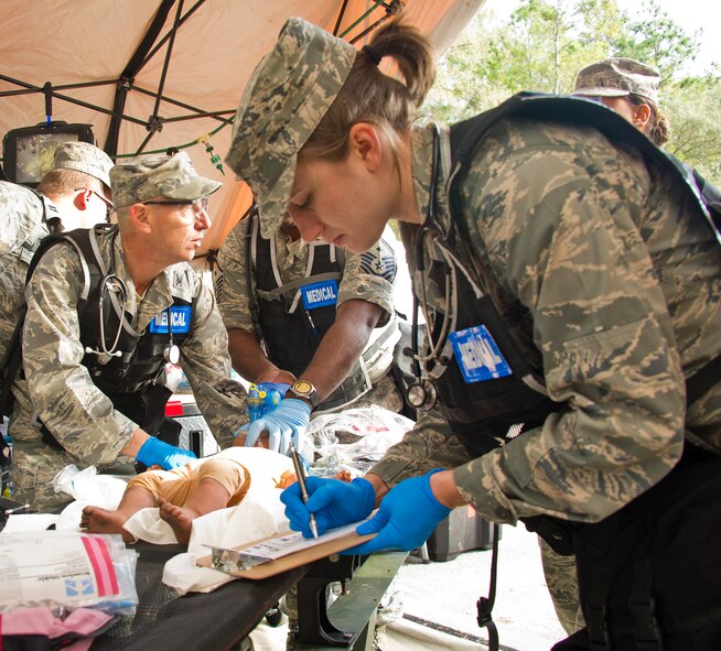 Air National Guard 2nd Lt. Sarah Kathe, 116th Medical Group (MDG) nurse, Robins Air Force Base, Ga., fills out a patient chart while other members of the medical team treat a simulated injured baby during Operation Sunrise Rescue at Camp Blanding Joint Training Center, Fla., Nov. 18, 2011.  The 116th MDG received a perfect score in the joint force exercise to test their skills as a Chemical, Biological, Radiological, Nuclear, and High Yield Explosive Enhanced Response Force Package.  (National Guard photo by Master Sgt. Roger Parsons/Released)