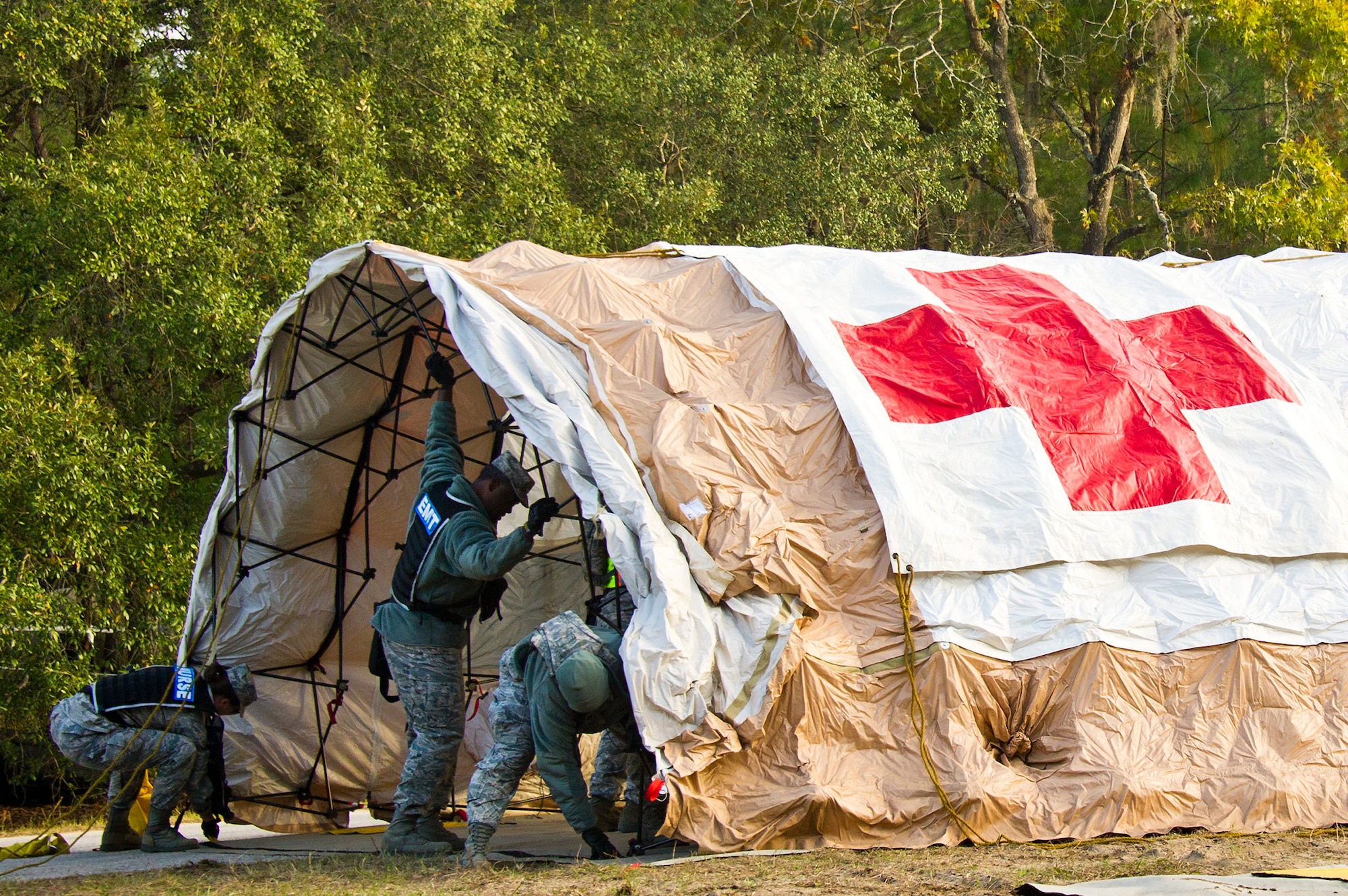 Air National Guard medical personnel from the 116th Medical Group (MDG), Robins Air Force Base, Ga., and the 165th MDG, Savannah, Ga.,  set up a tent used for cold zone triage during Operation Sunrise Rescue at Camp Blanding Joint Training Center, Fla., Nov. 18, 2011.  The combined medical group received a perfect score in the joint force exercise to test their skills as a Chemical, Biological, Radiological, Nuclear, and High Yield Explosive Enhanced Response Force Package.  (National Guard photo by Master Sgt. Roger Parsons/Released)
