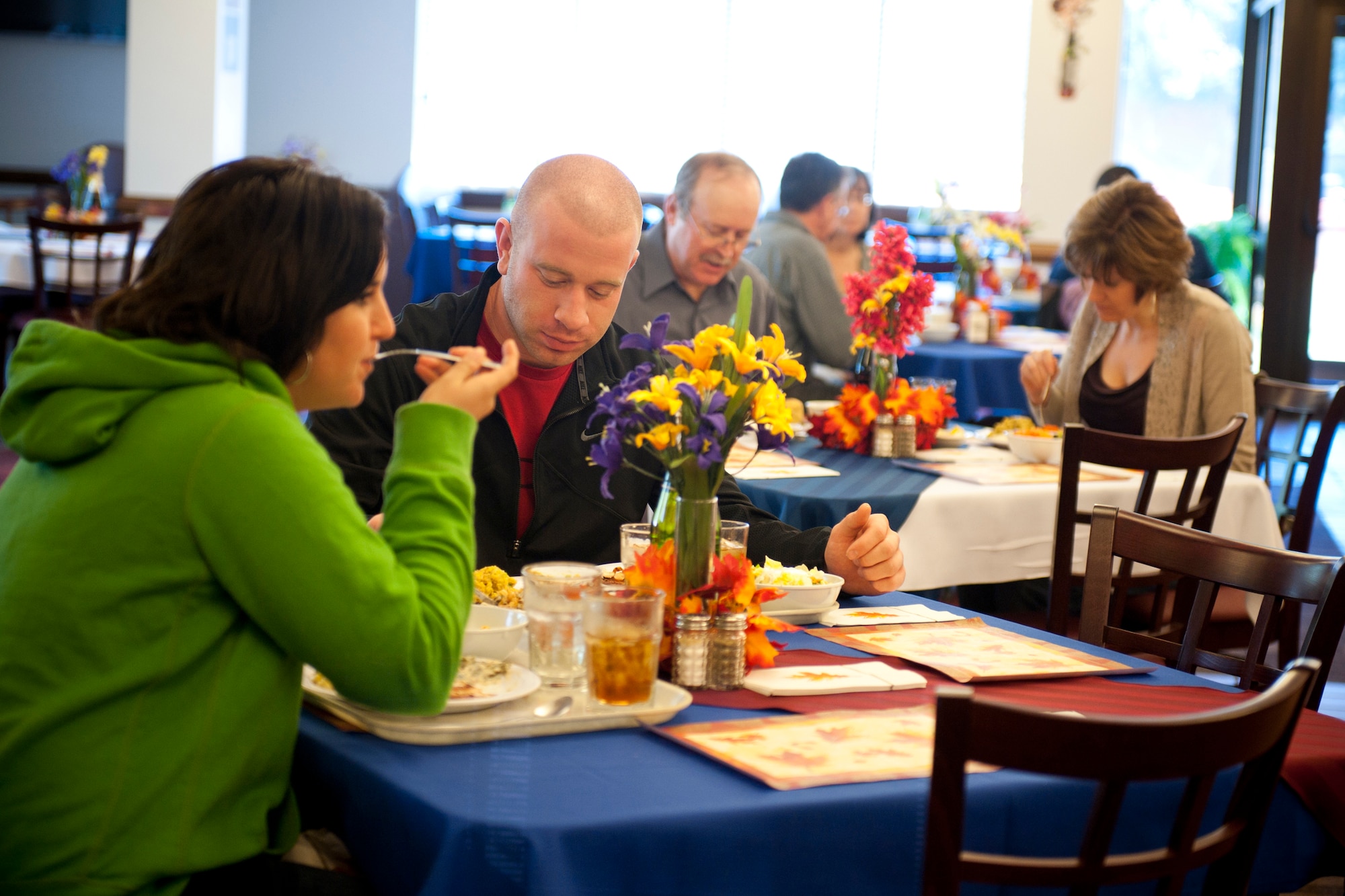 Airmen, friends and family of Team Moody take part in a Thanksgiving meal at the Georgia Pines Dining Facility, Moody Air Force Base, Ga., Nov. 24, 2011. The DFAC served a lunch and dinner meal for those who did not have a place to eat for Thanksgiving or wanted to enjoy a meal without the having to prepare one of their own. (U.S. Air Force photo by Staff Sgt. Jamal D. Sutter/Released) 