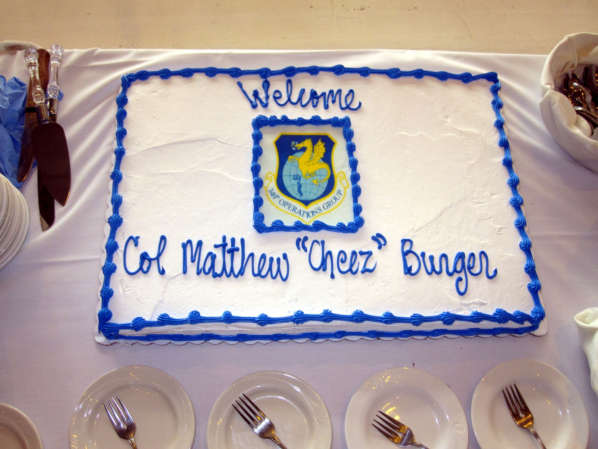 TRAVIS AIR FORCE BASE, Calif. -- Col. Matthew 'Cheez' Burger, is presented a cake at the assumption of command of the 349th Operations Group at a ceremony here Nov. 19, 2011. (U.S. Air Force courtesy photo)