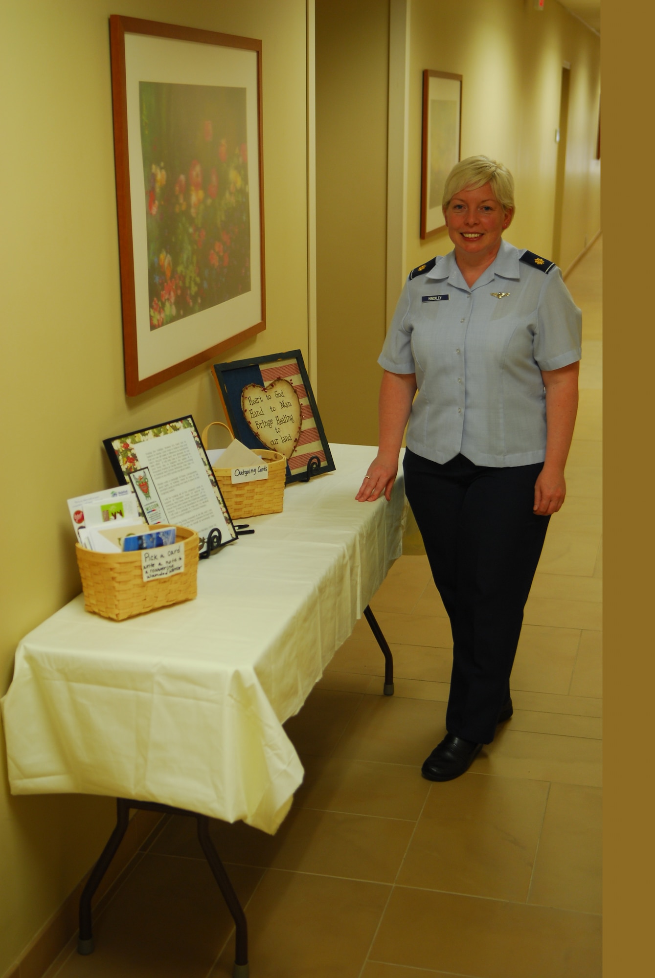 VANDENBERG AIR FORCE BASE, Calif. - Maj. Dawn Hinckley, a 30th Medical Group health care integrator, stands outside of her office, Room 323, 30th MDG clinic, where she has set up a table to collect holiday cards from Team V members to send to injured service members at Walter Reed National Medical Center, Bethesda, Md. (U.S. Air Force photo/Senior Airman Steve Bauer) 