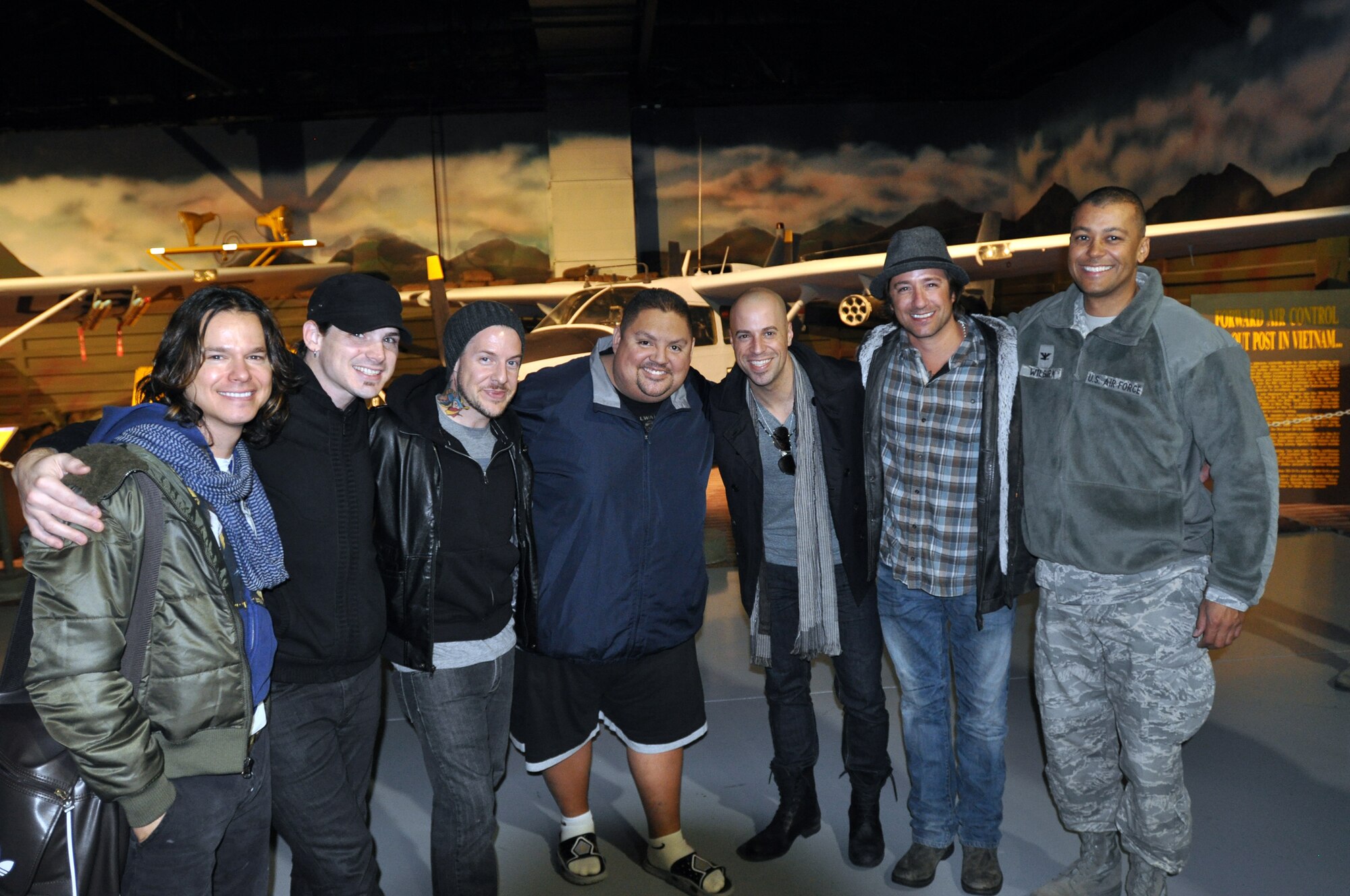Operation Seasons Greetings -- Tour for the Troops 2011, featuring the rock band Daughtry, comedian Gabriel "Fluffy" Iglesias and the Band of the U.S. Air Force Reserve, departed from Robins Air Force Base, Ga., Nov.  28, on a 13-day, six concert swing through Southwest Asia and Europe. From left, Daughtry band members Robin Diaz (drums), Brian Craddock (guitar), Josh Paul (bass), comedian Fluffy Iglesias, Chris Daughtry (vocals/guitar), Josh Steely (guitar), and Col. Joe Wilburn, Air Force Reserve Recruiting Service commander and  OSG 2011 troop commander. (U.S. Air Force photo/Philip Rhodes)