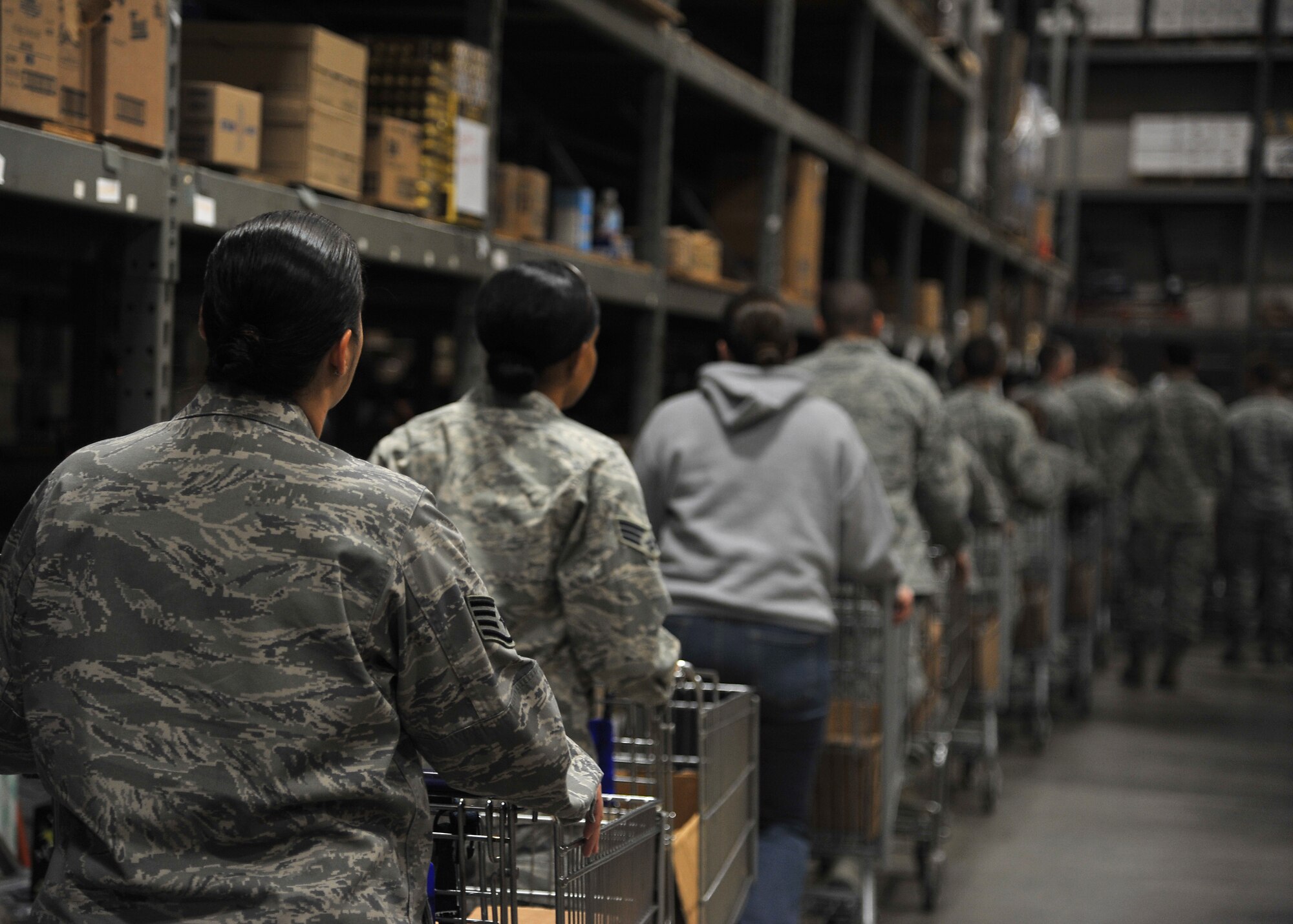 GOODFELLOW AIR FORCE BASE, Texas -- Airmen line up with shopping carts collecting food items at the Commissary warehouse Nov. 22 during this year’s Operation Warmheart.  Operation Warmheart is ran by the First Sergeants Council and provides food for families in need. (U.S Air Force photo/Airman 1st Class Michael Smith)
