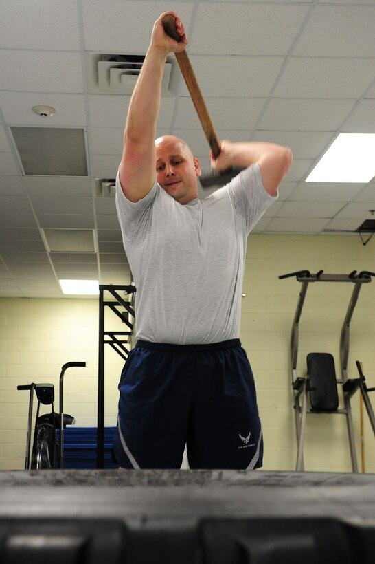 U.S. Air Force Staff Sgt. Eric Thomsen, 1st Maintenance Squadron lead physical training leader, demonstrates the correct way to execute an exercise during a PT session at Langley Air Force Base, Va., Nov. 22, 2011. Airmen participate twice a week in circuits that are designed to be intense, but informative, teaching them challenging and fun ways to work out to improve their fitness. (U.S. Air Force photo by Airman 1st Class Kayla Newman/Released)