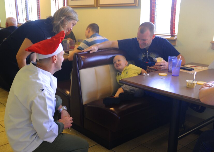 Col. David Been (left), 7th Bomb Wing commander, and his wife Elizabeth talk to guests during the Thanksgiving dinner at the Longhorn Dining Facility Nov. 24, 2011, at Dyess Air Force Base, Texas. First sergeants and commanders helped serve food to airmen, retirees and their families. (U.S. Air Force photo by Airman 1st Class Cierra Bullock/Released)