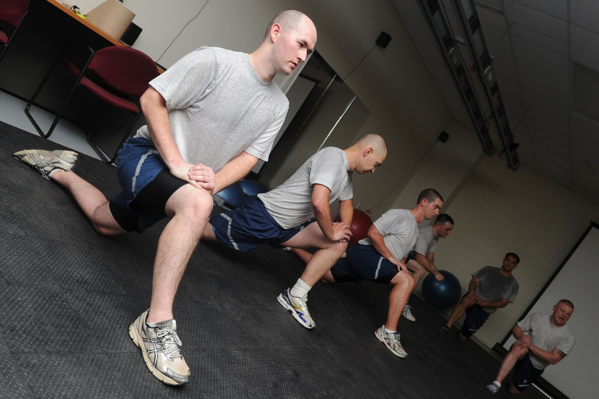 Airmen of the 1st Maintenance Squadron stretch after participating in a physical training session at Langley Air Force Base, Va., Nov. 22, 2011. The Airmen’s PT scores, confidence and attitudes have improved as a result of the unique program designed by the unit physical training leader. (U.S. Air Force Photo by Airman 1st Class Racheal Watson/Released)