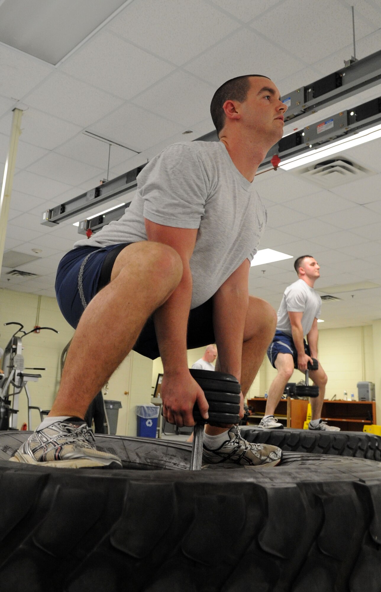 U.S. Air Force Airman 1st Class Jason Noyes, 1st Maintenance Squadron low observable aircraft structural maintenance apprentice, and Senior Airman Chris Buentello, 1st MXS low observable aircraft structural maintenance journeyman, participate in an intense physical training regimen at Langley Air Force Base, Va., Nov. 22, 2011. The unit’s head physical training leader designed a PT regimen with circuits designed to be intense and teach Airmen challenging and fun new ways to work out to improve their overall fitness. (U.S. Air Force Photo by Airman 1st Class Racheal Watson/Released)