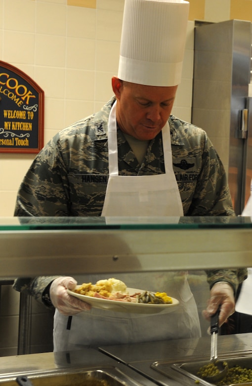 Colonel Erik Hansen serves Thanksgiving dinner to Airmen and retirees at the Joint Base Charleston Dining Facility at JB Charleston - Air Base  Nov.24. Hansen, along with other unit commanders, chiefs and their families, took time out of their own Thanksgiving festivities to serve their fellow Airmen and retirees. Hansen is the 437th Airlift Wing commander. (U.S. Air Force photo/Airman 1st Class Ashlee Galloway)