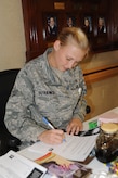 Senior Airman Alyssa Dutkiewicz signs a pledge at the Medical Group clinic Nov.10. The pledge was part of the "Great American Smokeout" which is held every November as a means for smokers to quit smoking for at least one day. Dutkiewicz is a medical technician with the 628 MDG. (U.S. Air Force photo/Airman 1st Class Ashlee Galloway) 

